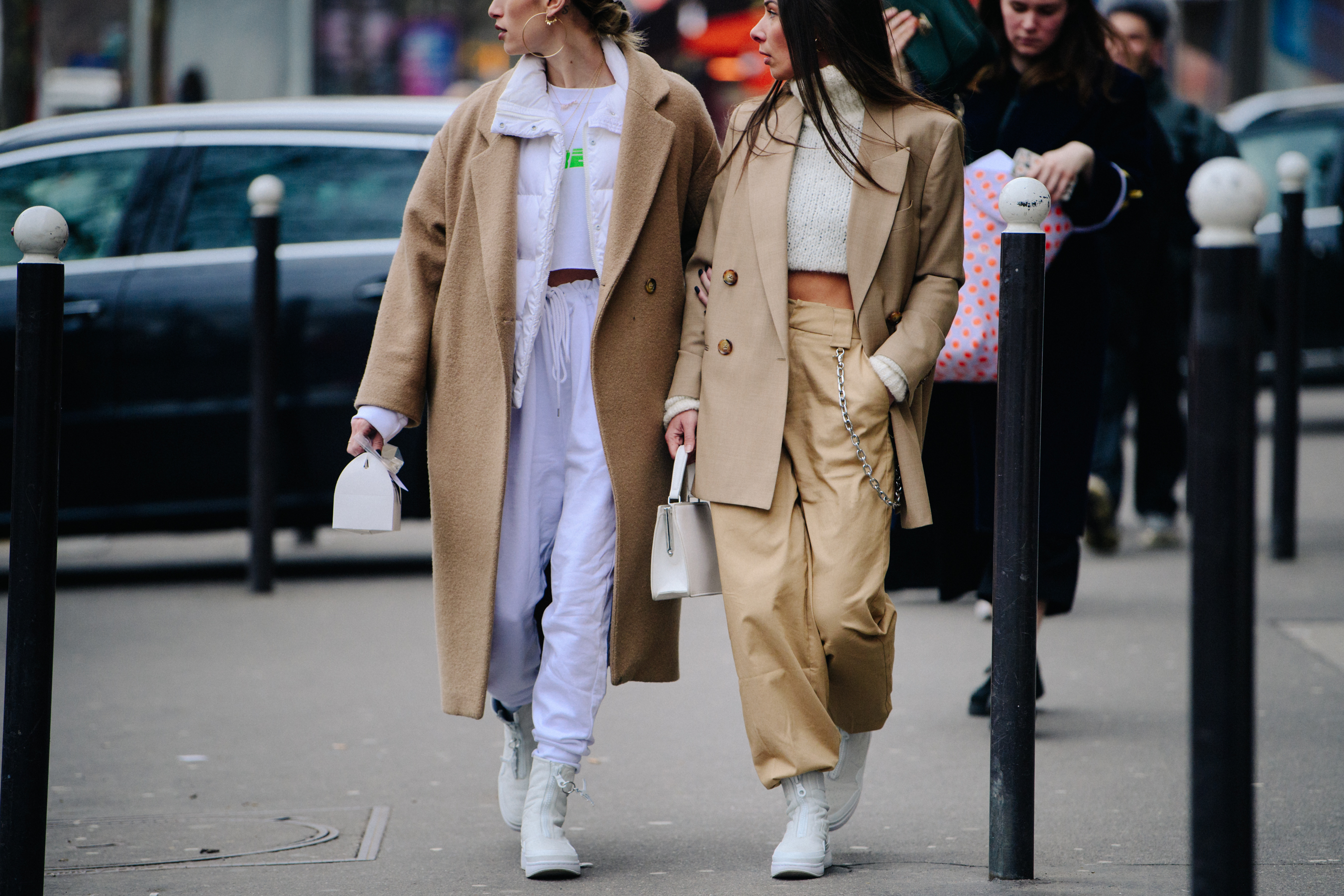Two women wearing white and tan outfits