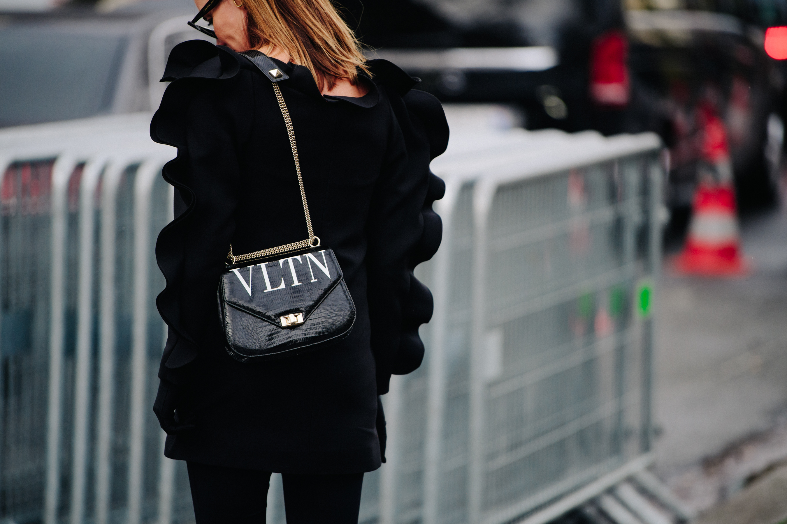 Woman carrying black chain bag