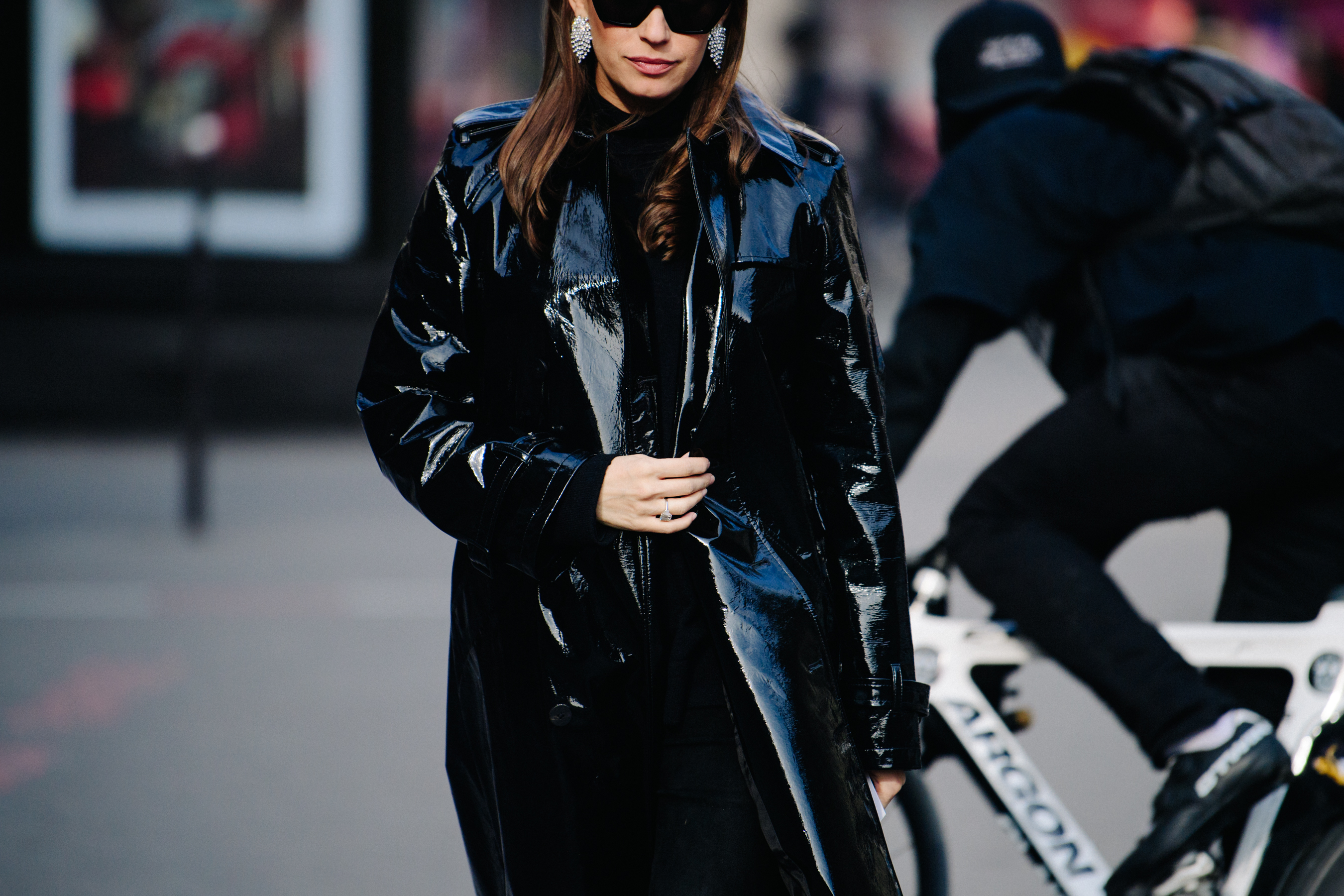 Woman wearing black patent coat