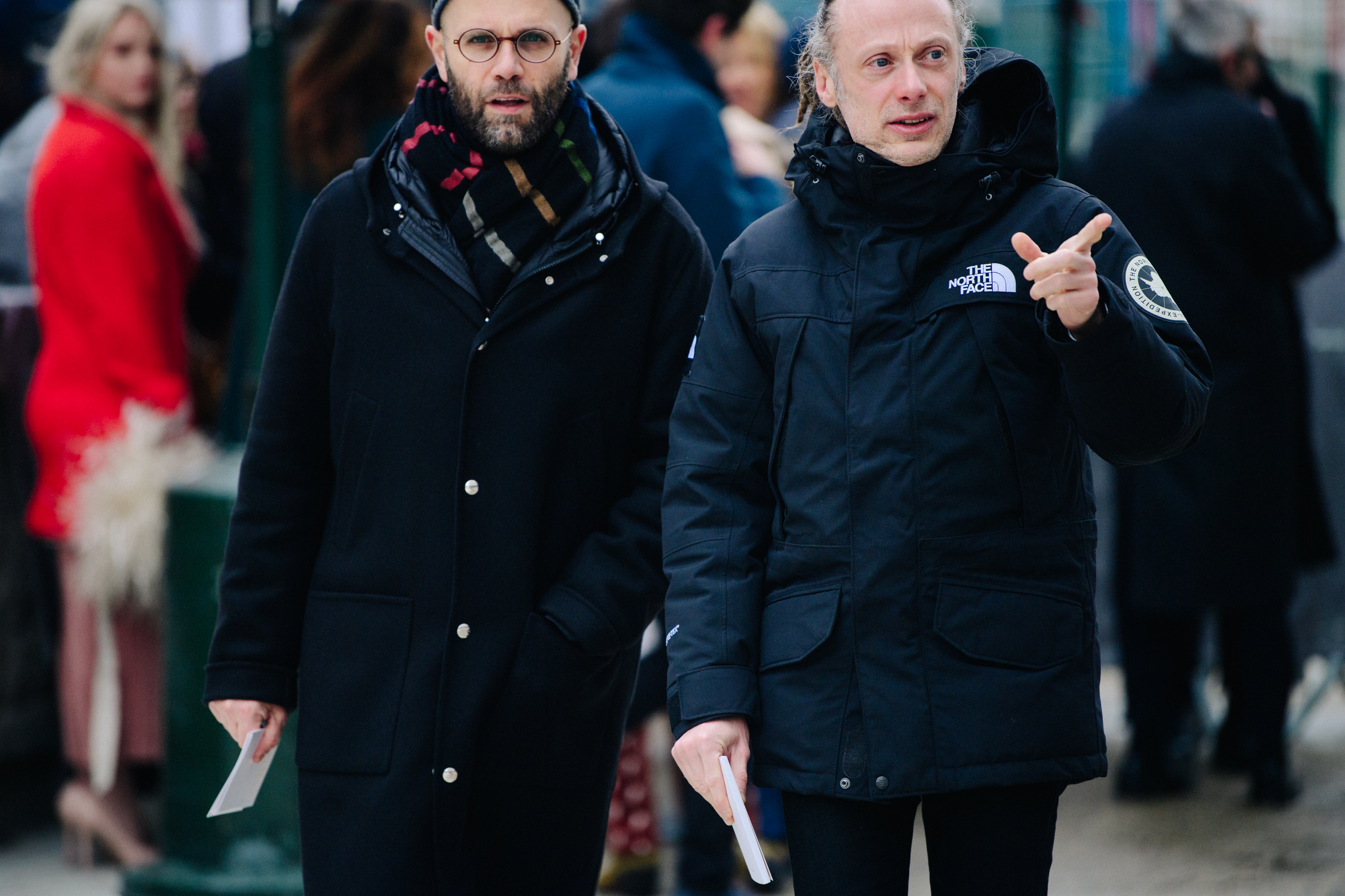 Two Italian men wearing black coats