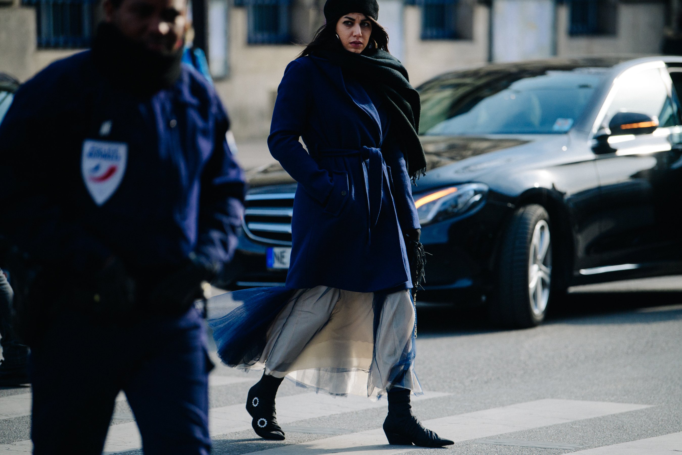 Woman wearing belted blue coat