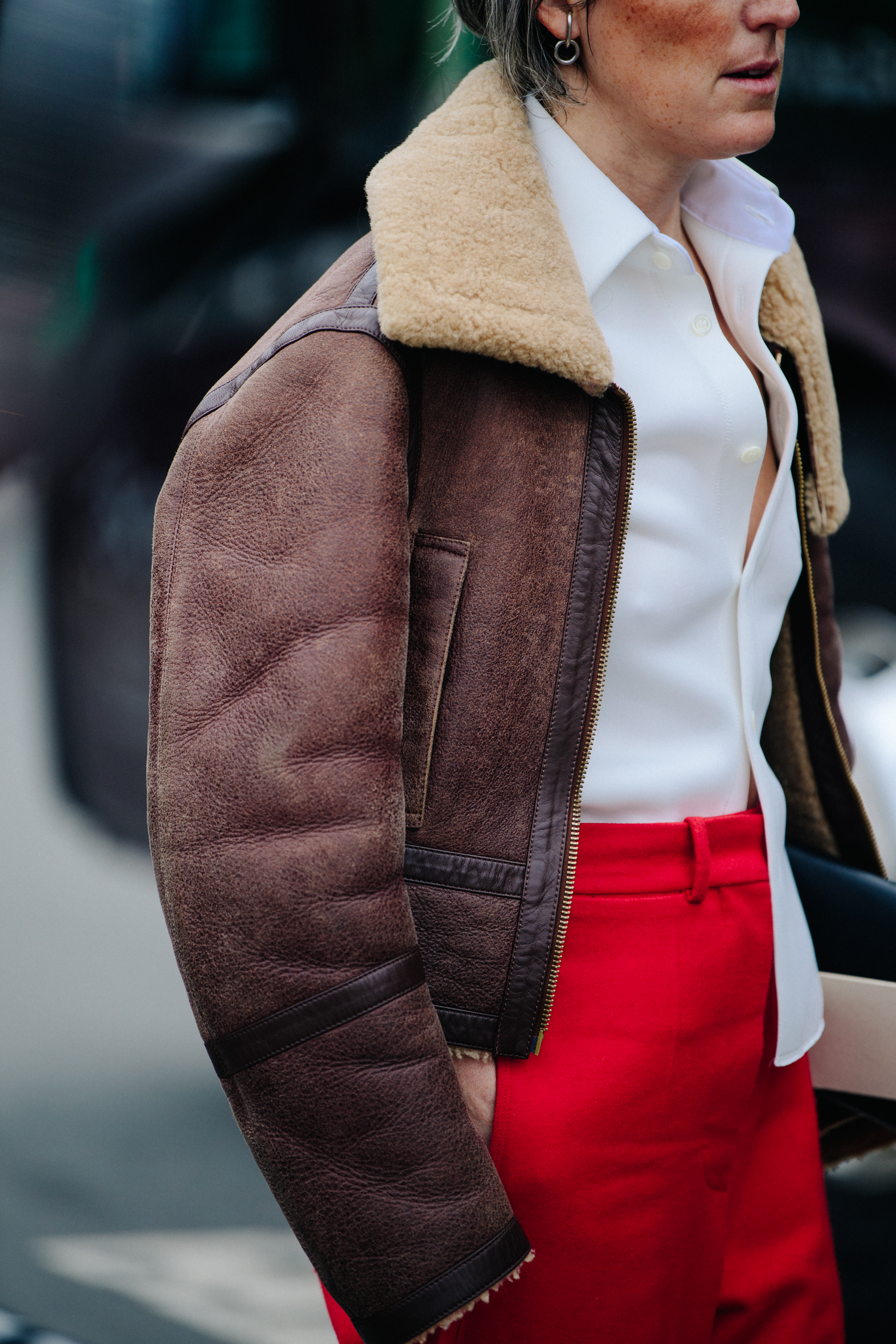 Woman wearing brown shearling jacket