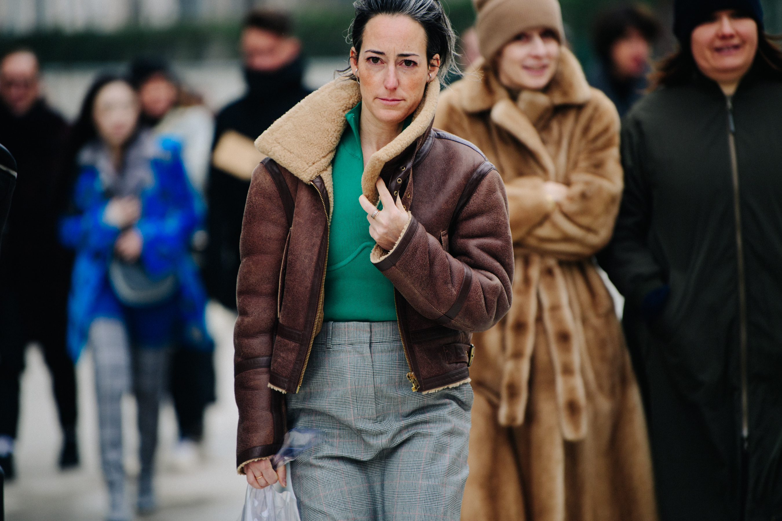 Woman wearing brown shearling jacket