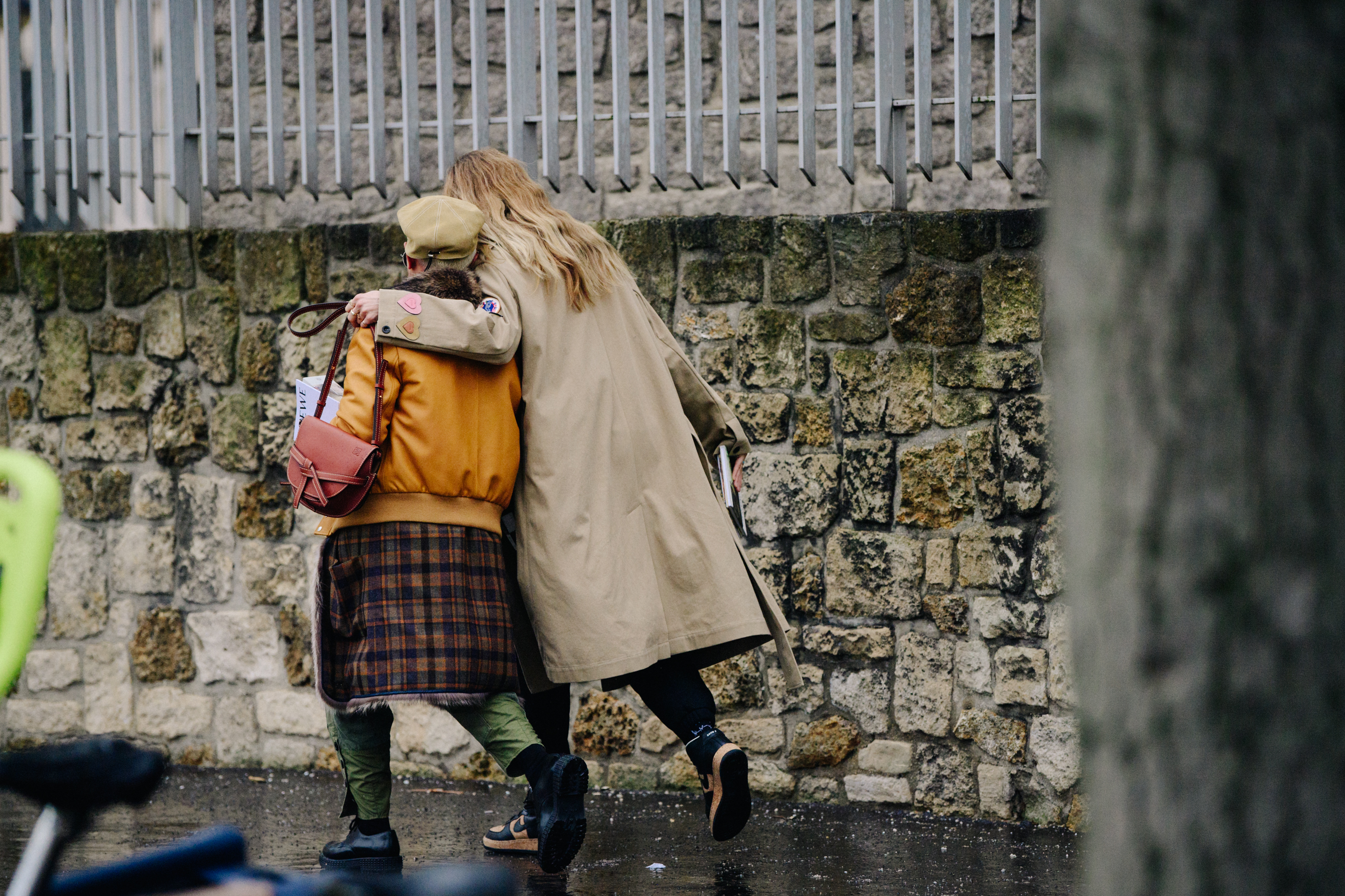 Two women wearing fashionable outfits