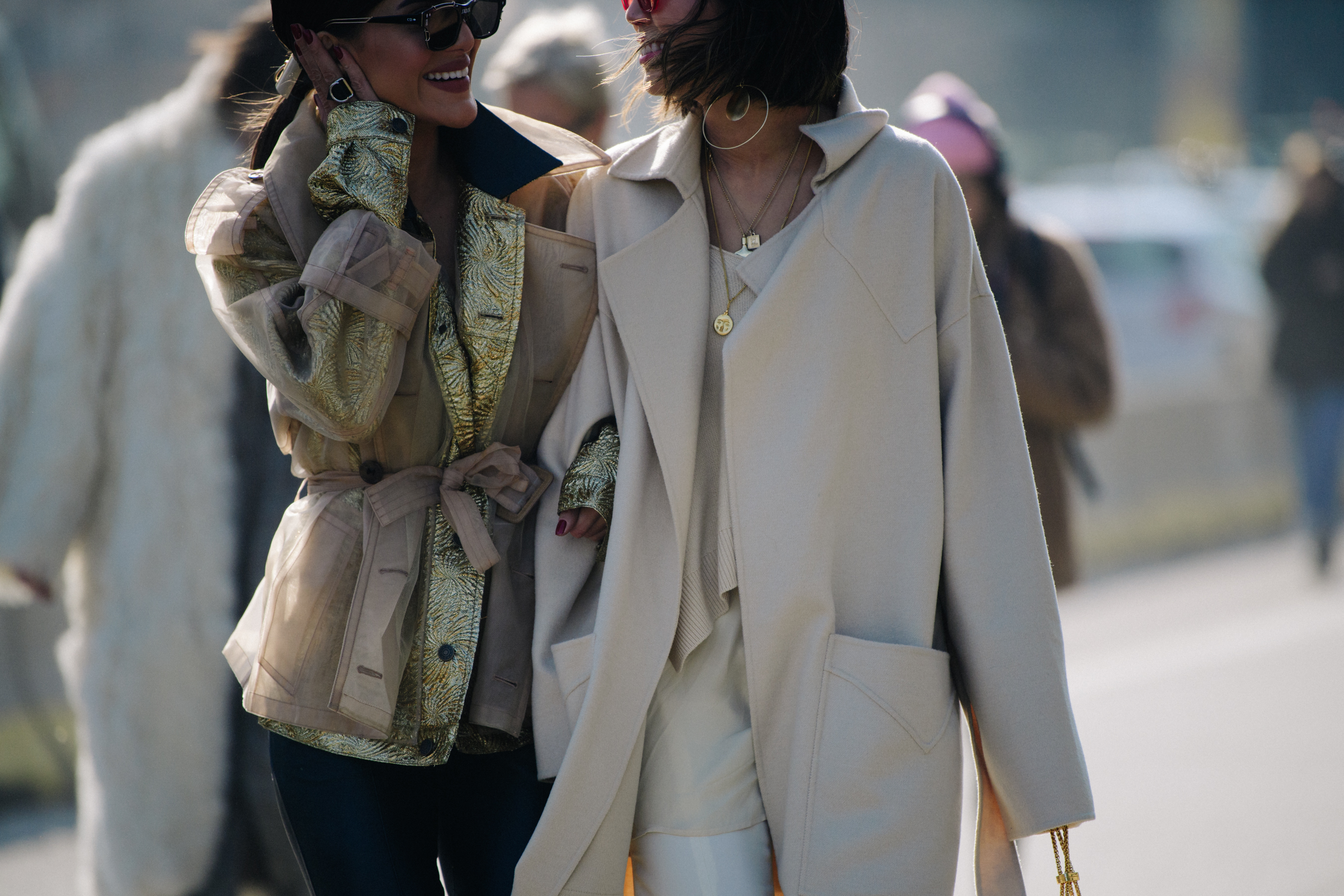 Two bloggers wearing pale coats