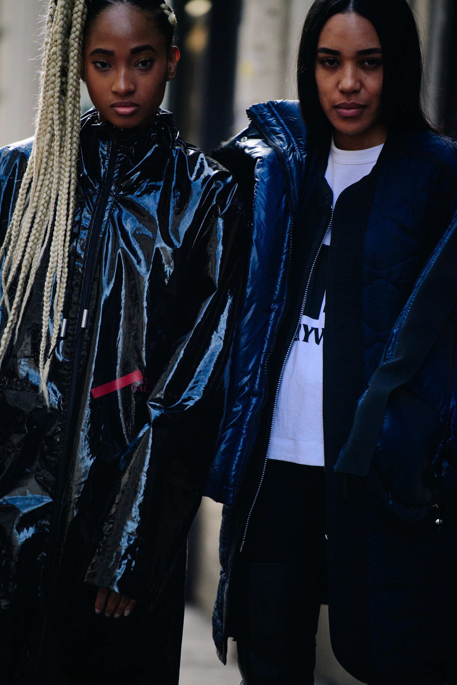 Two women wearing black coats
