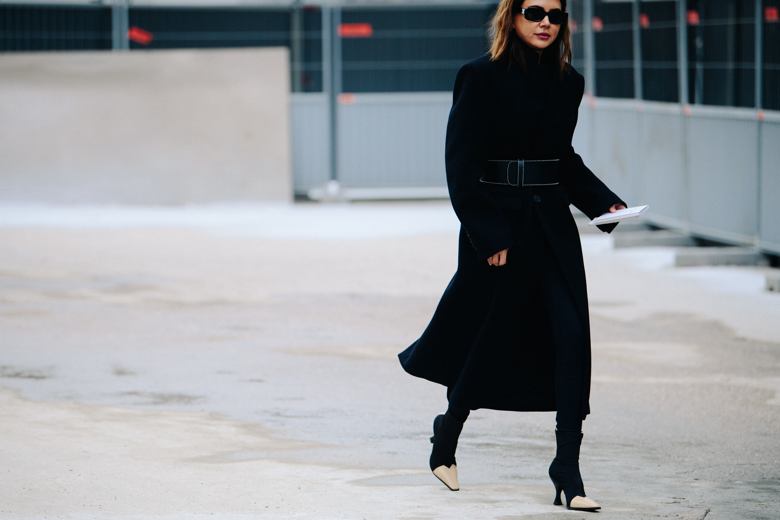 Woman wearing long black coat