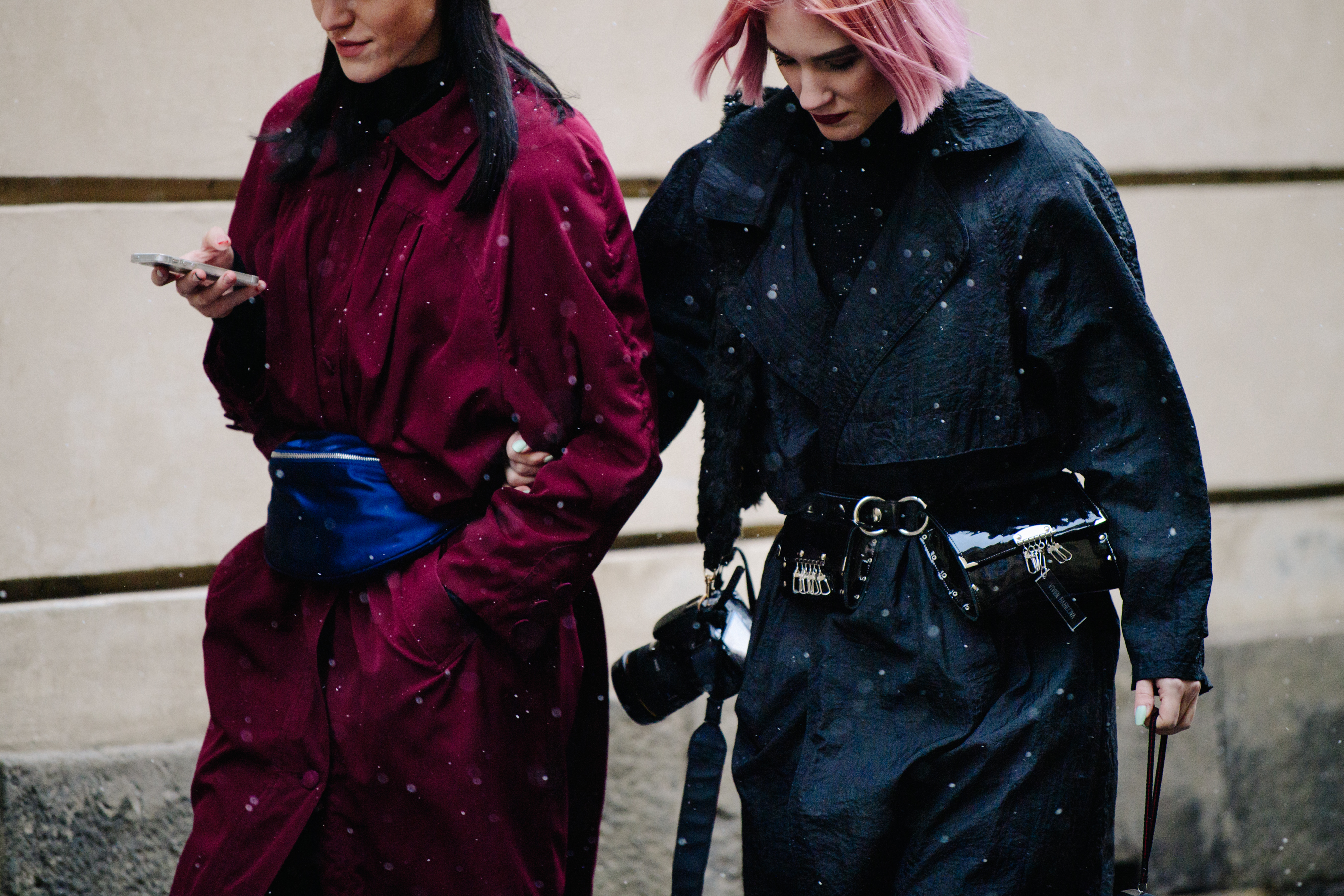 Two women wearing red and black