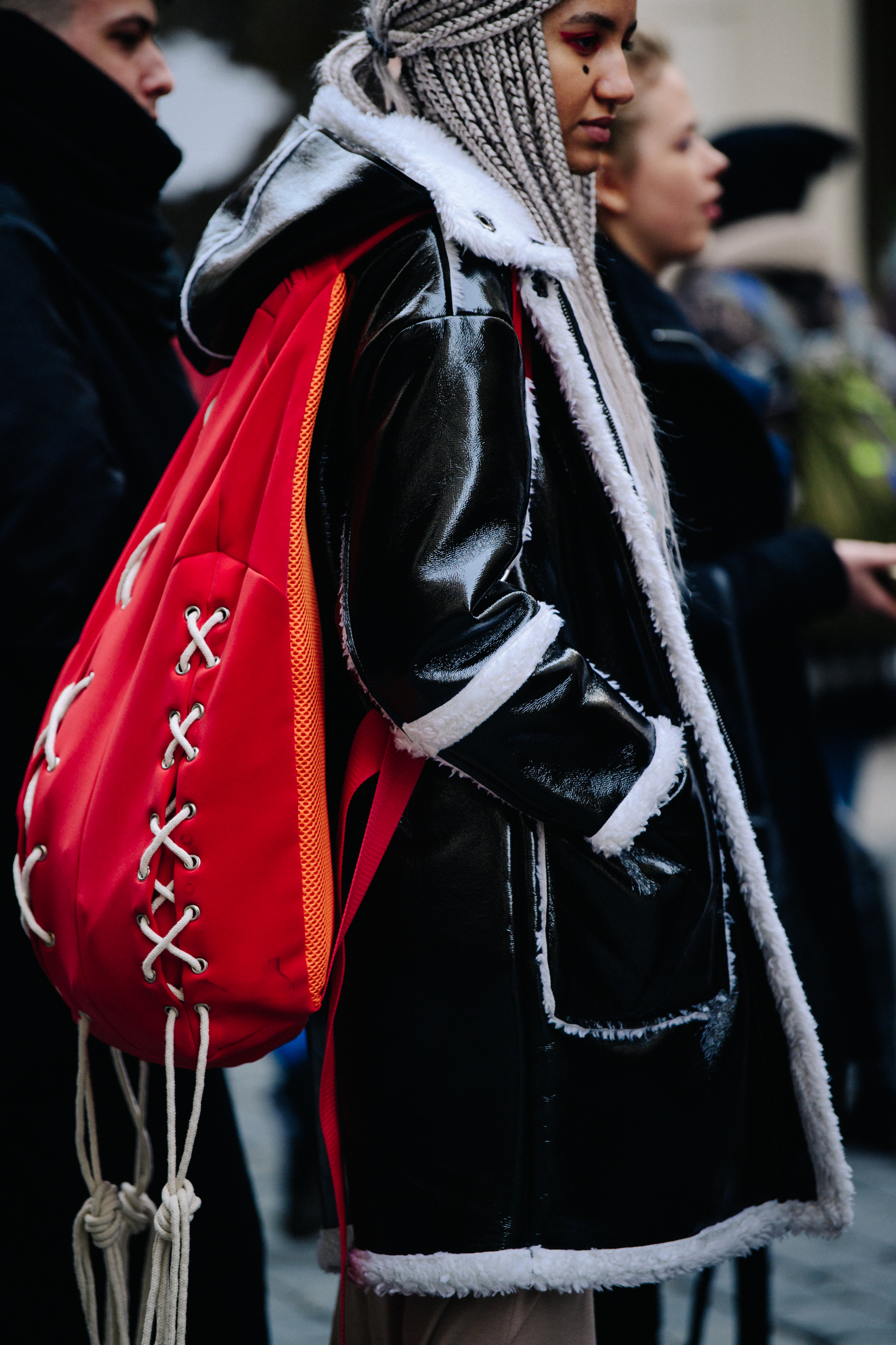 Woman wearing black patent coat
