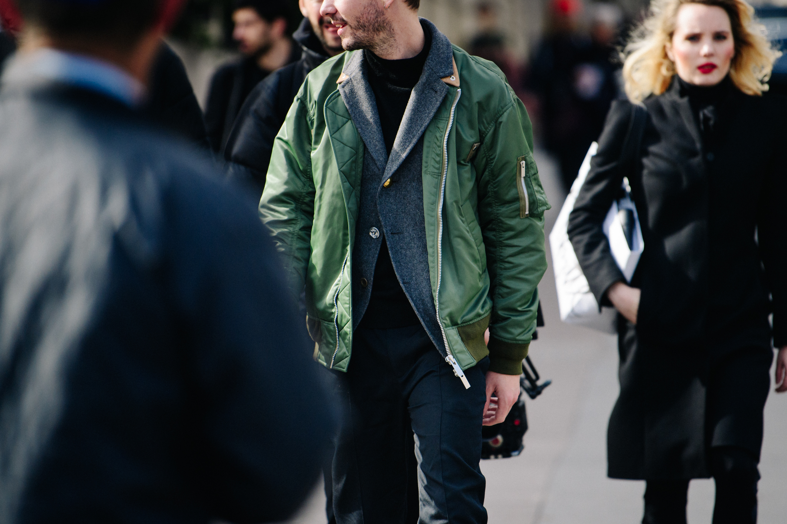American editor wearing green bomber jacket