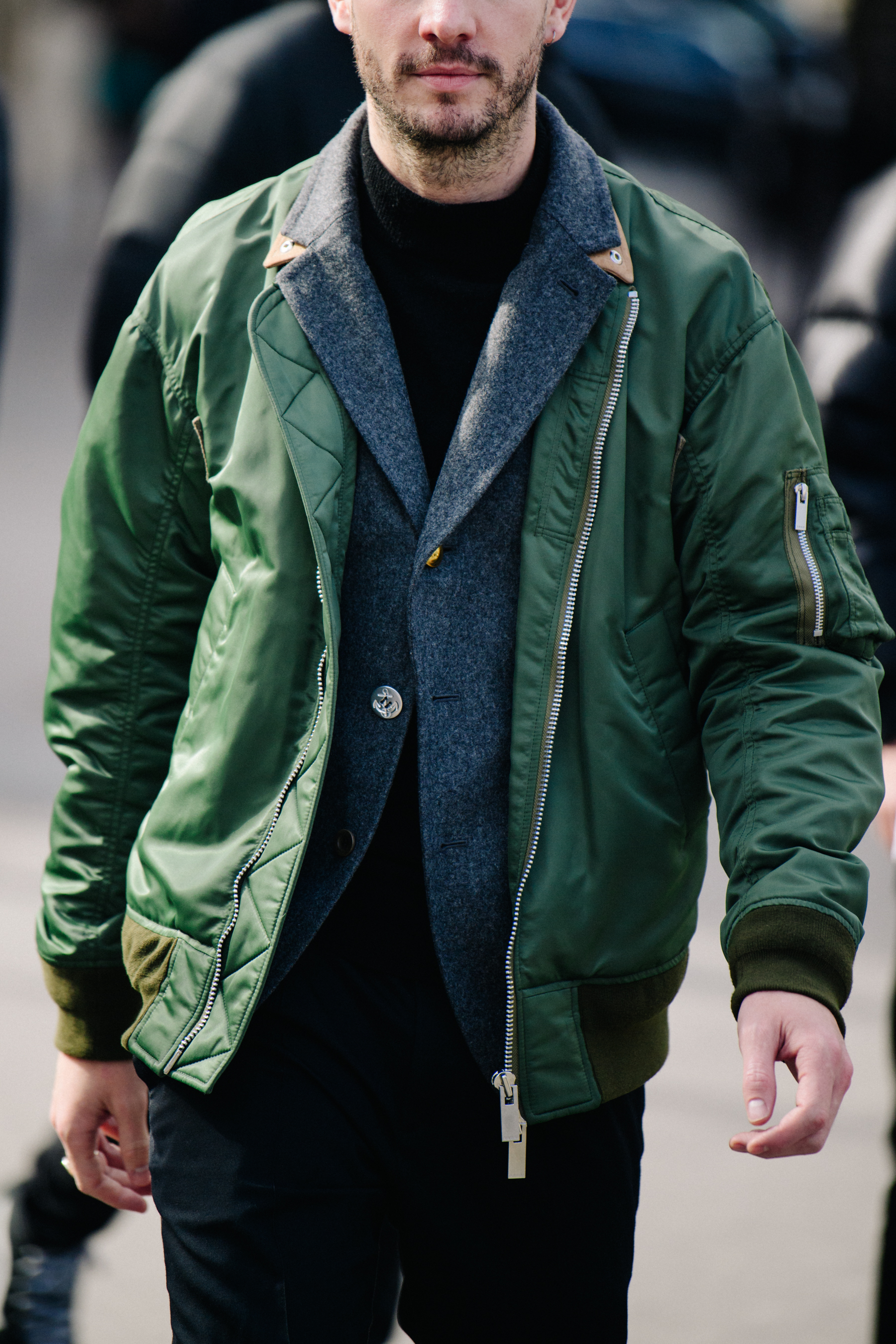 American editor wearing green bomber jacket