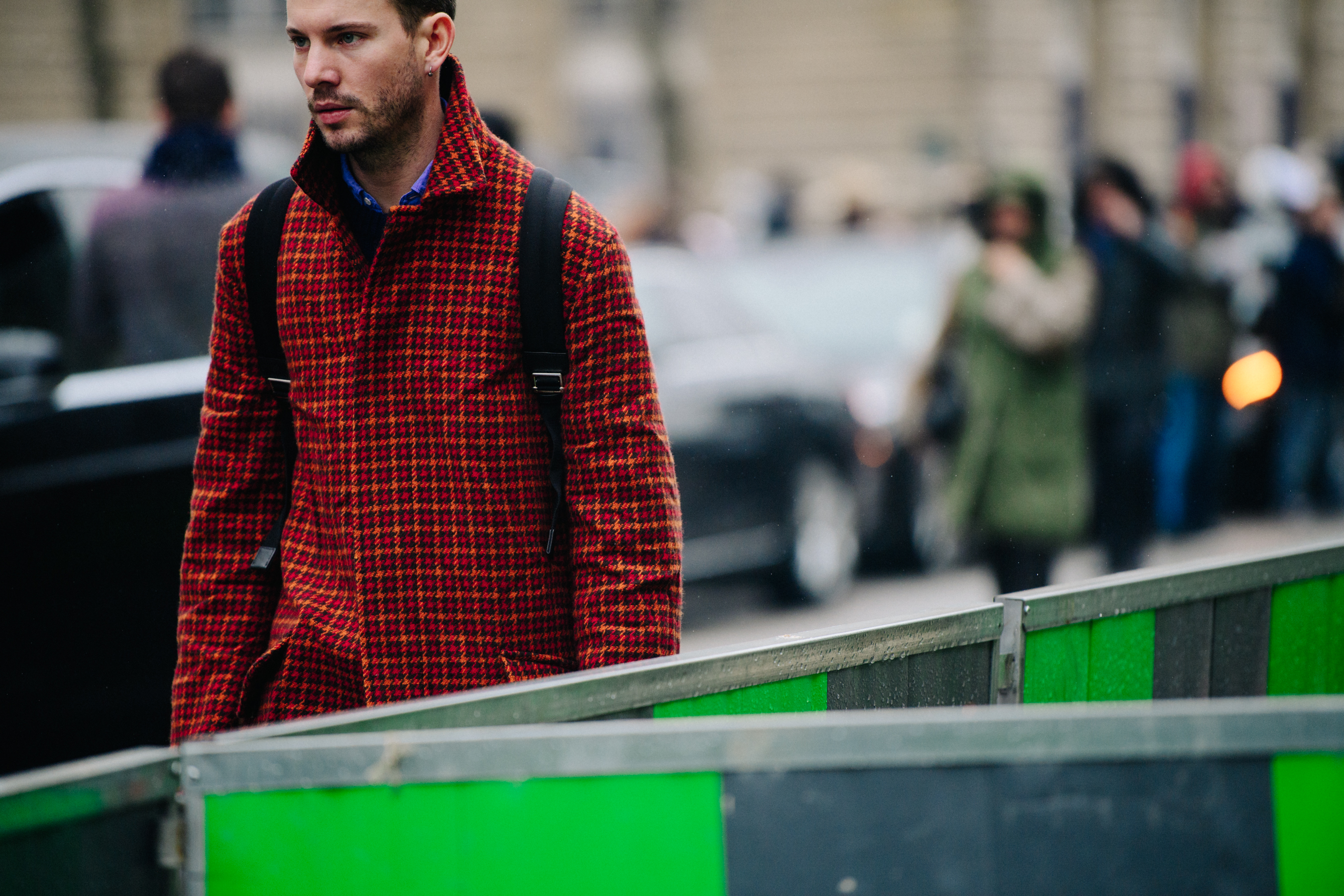 American editor wearing red pattern wool coat