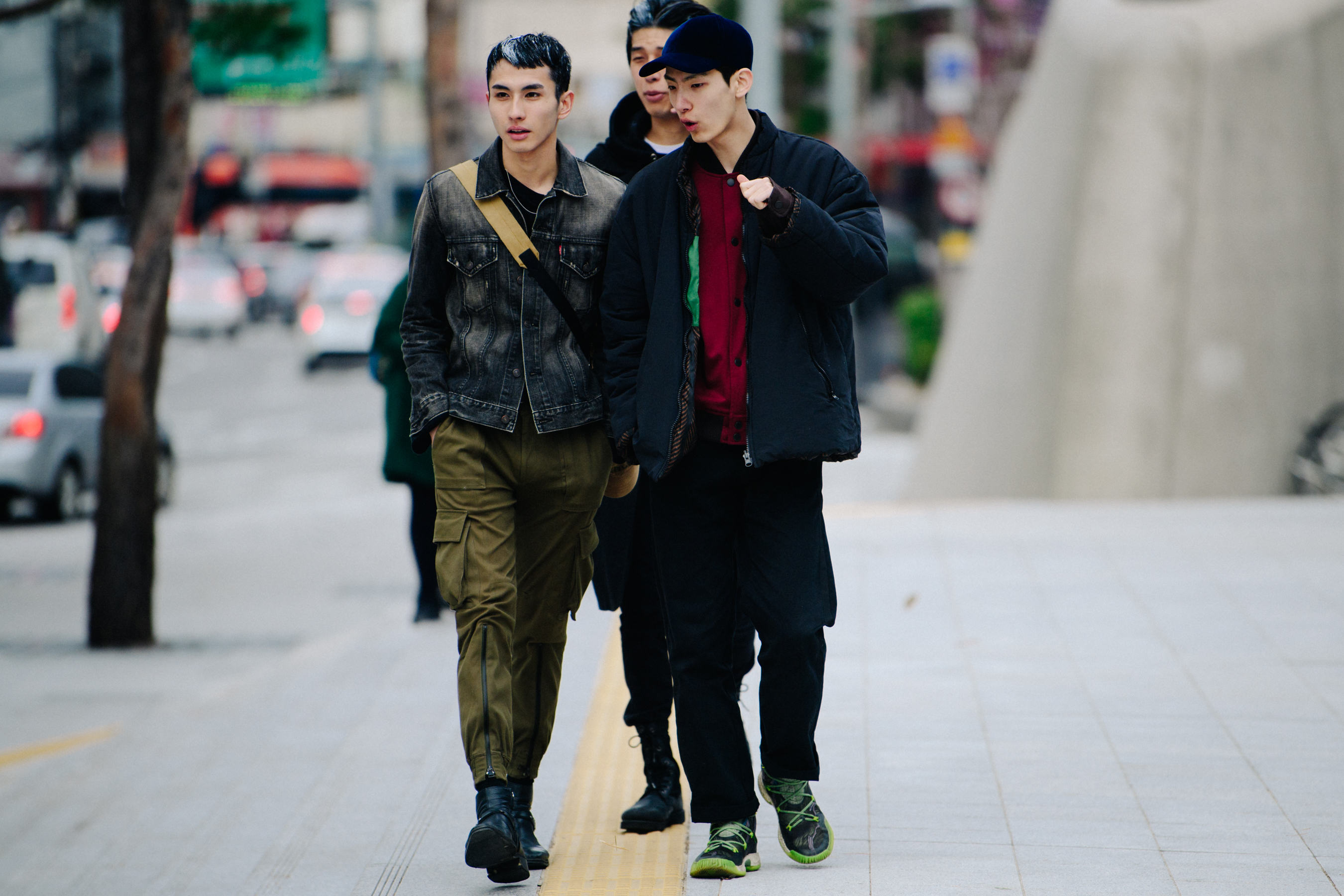 Three men wearing dark outfits