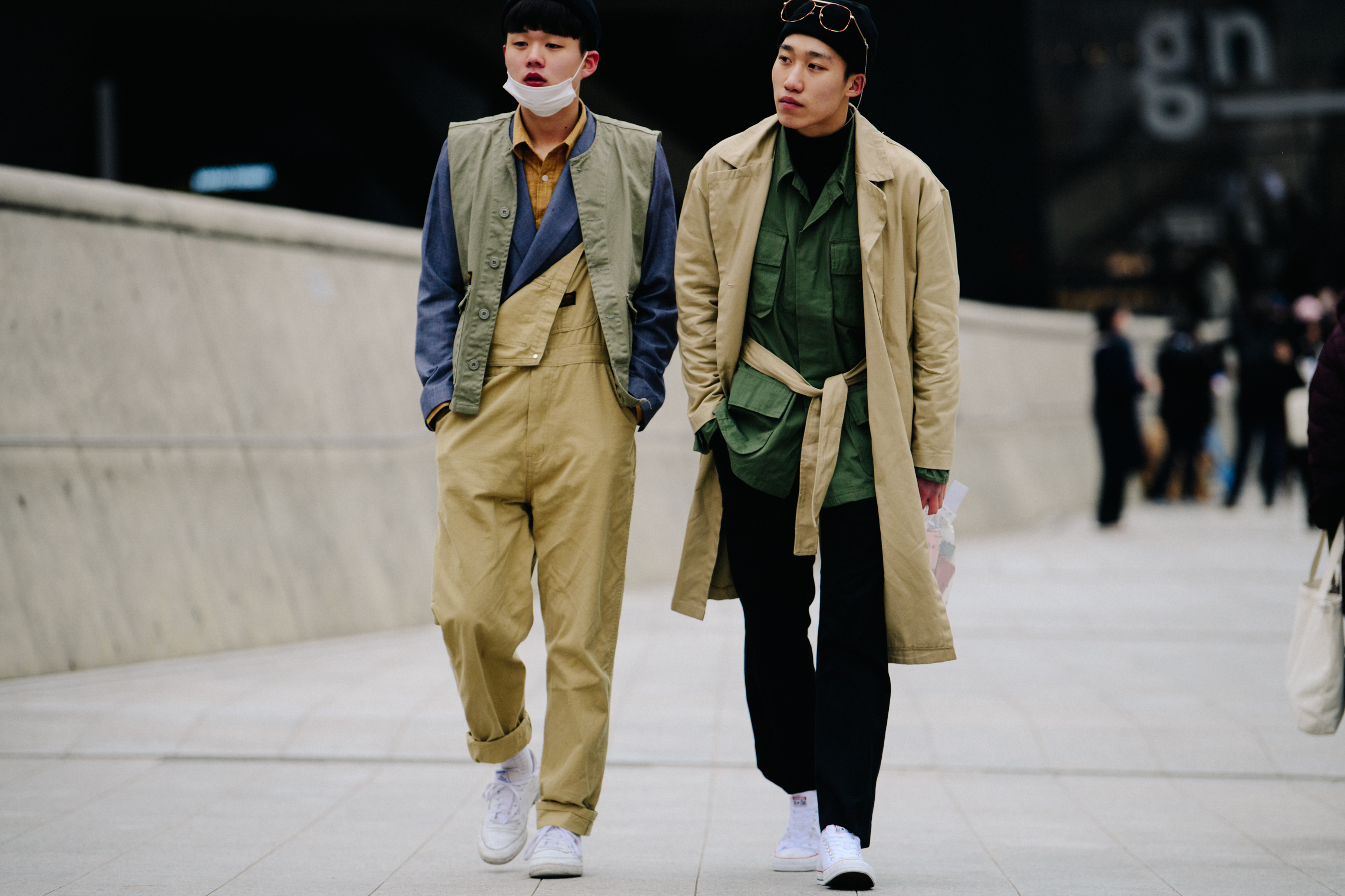 Two Asian men wearing tan outfits