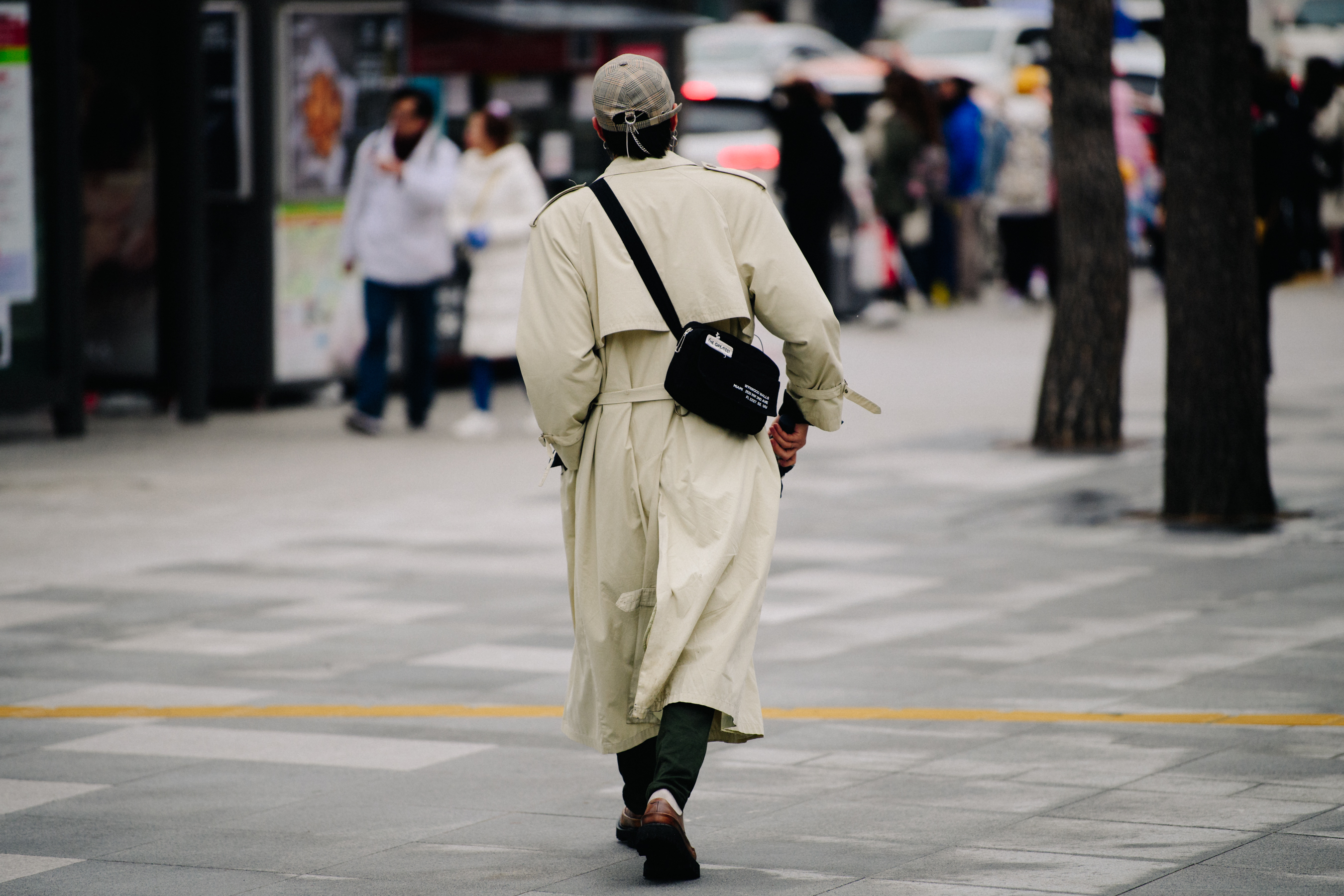 Man wearing long tan coat