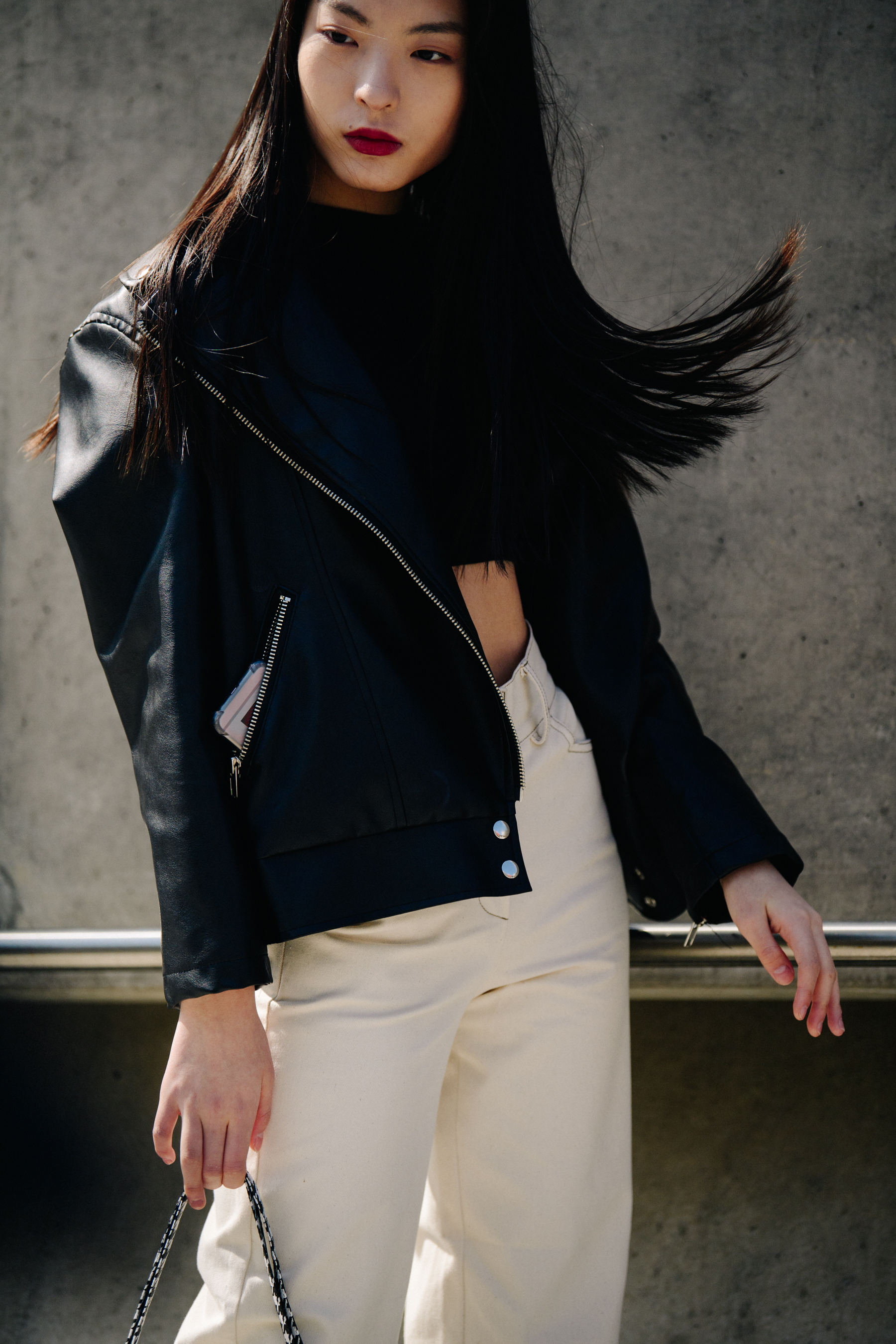 Asian woman wearing white pants