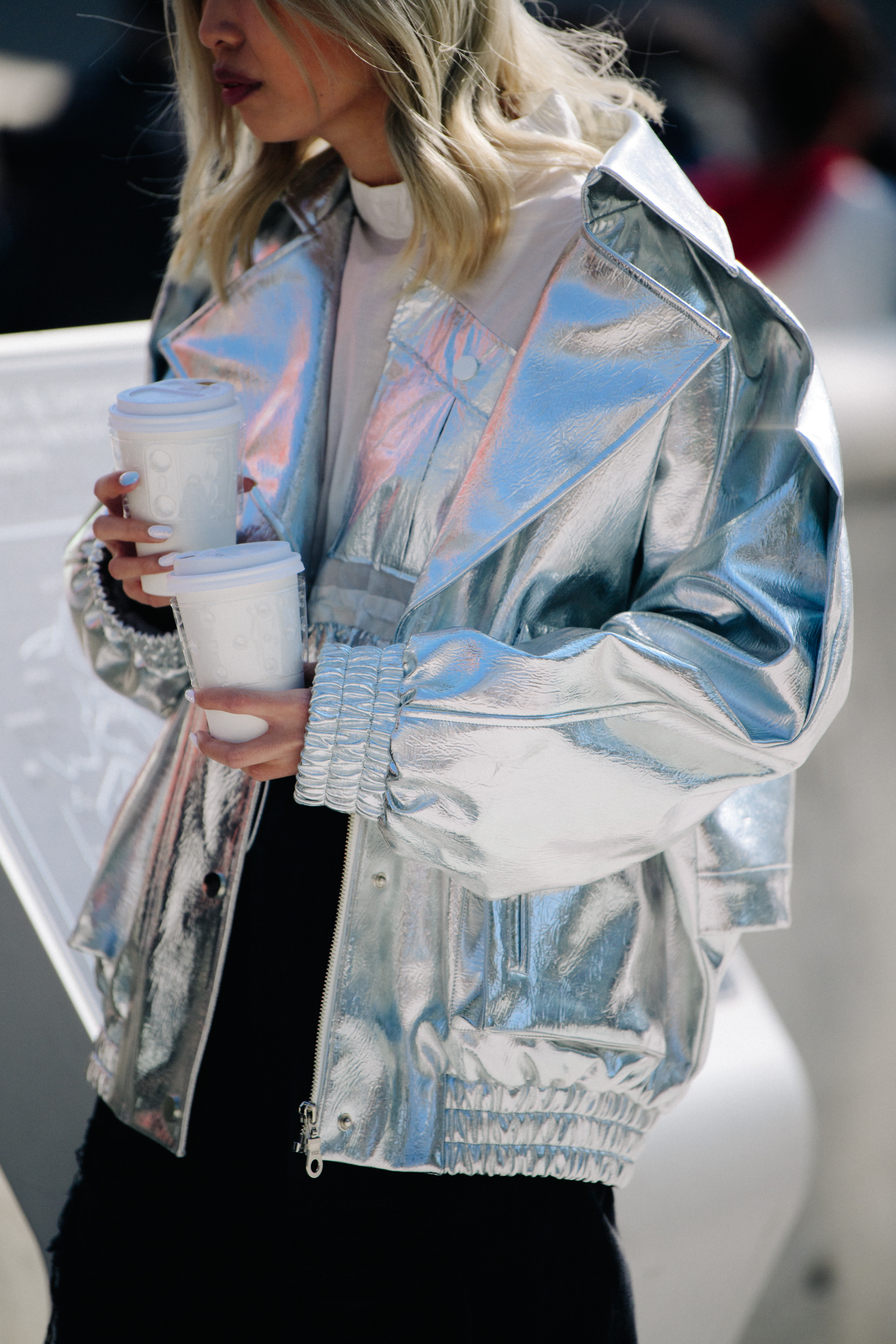 Asian woman wearing silver jacket