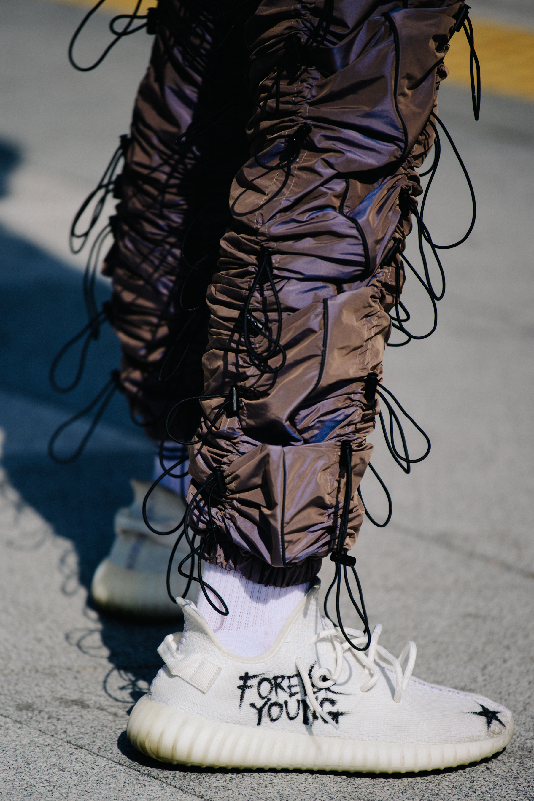 Man wearing white Yeezy sneakers