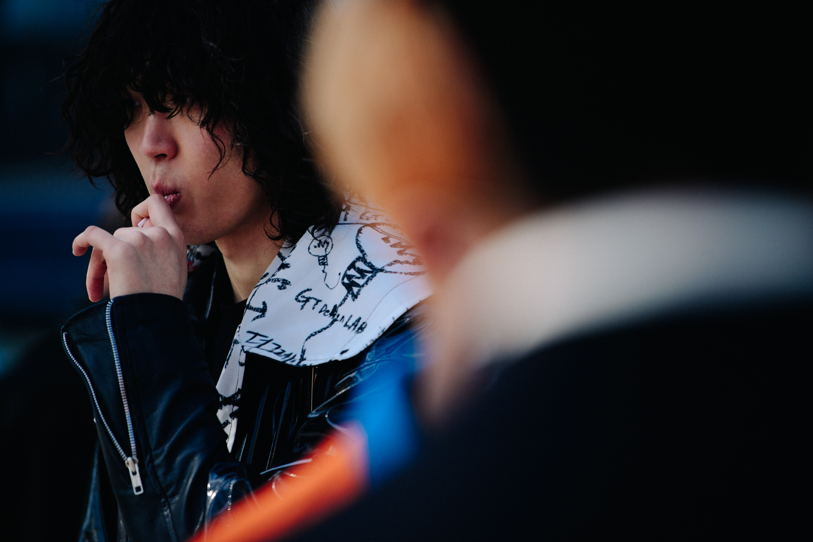 Asian man with long curly hair
