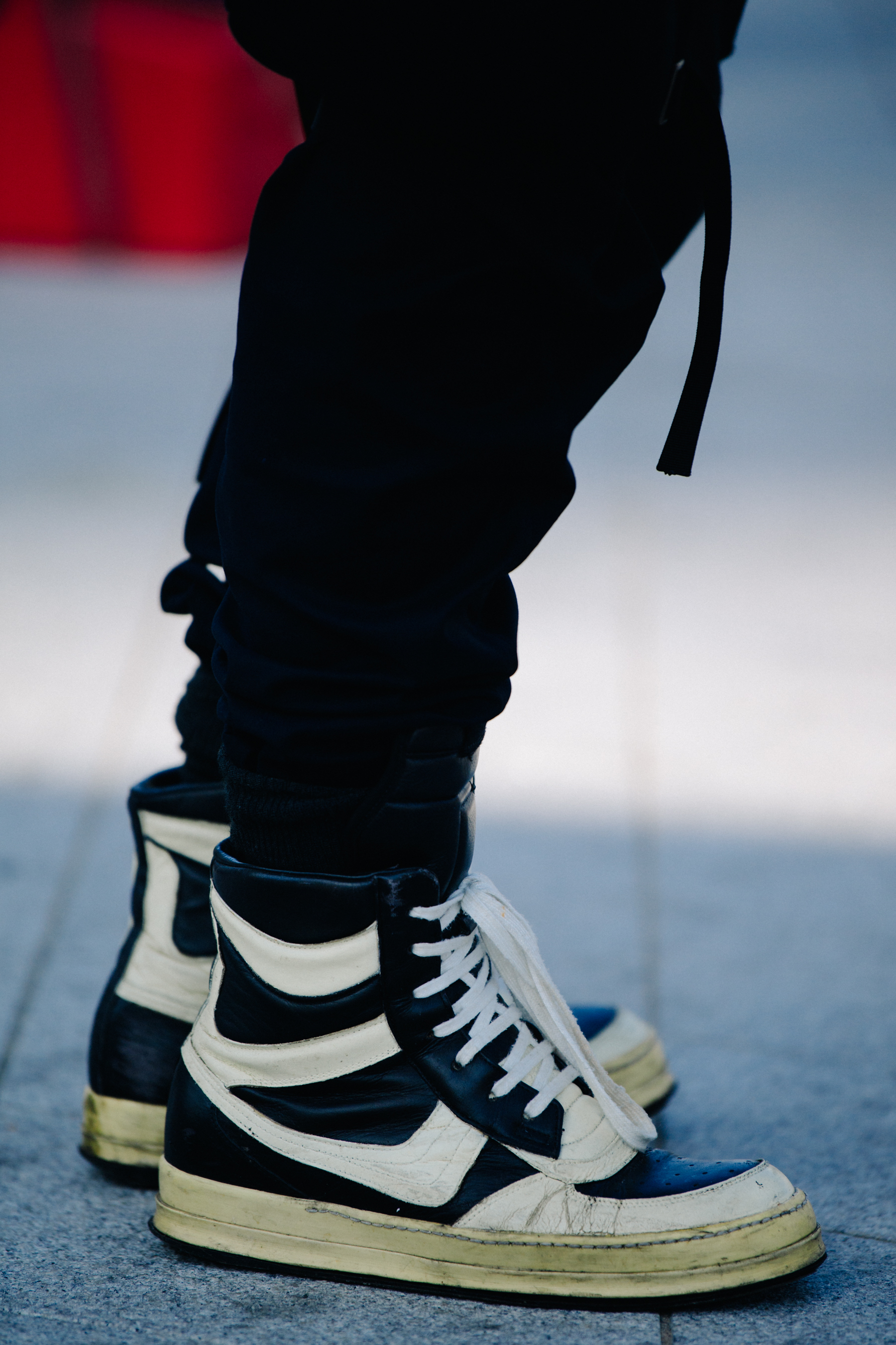 Man wearing white and black sneakers