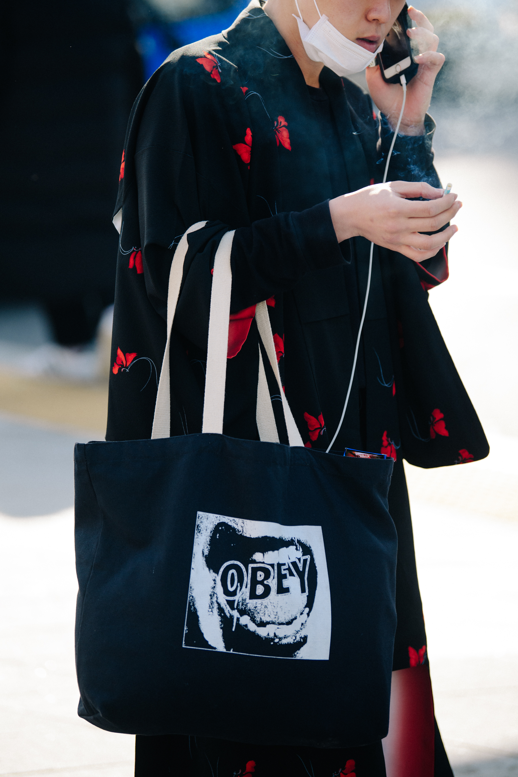 Man carrying Obey bag