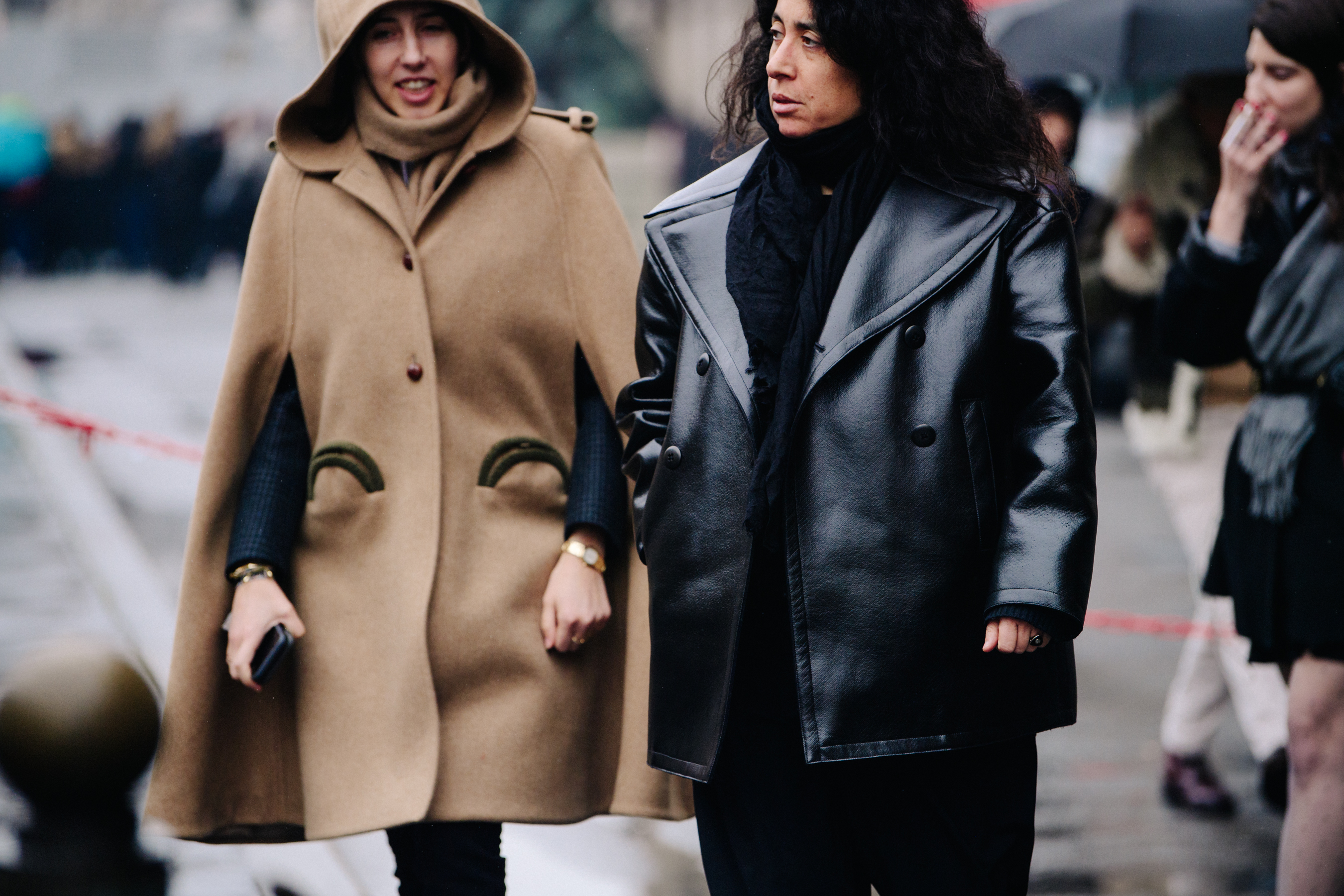 Two women wearing dark coats