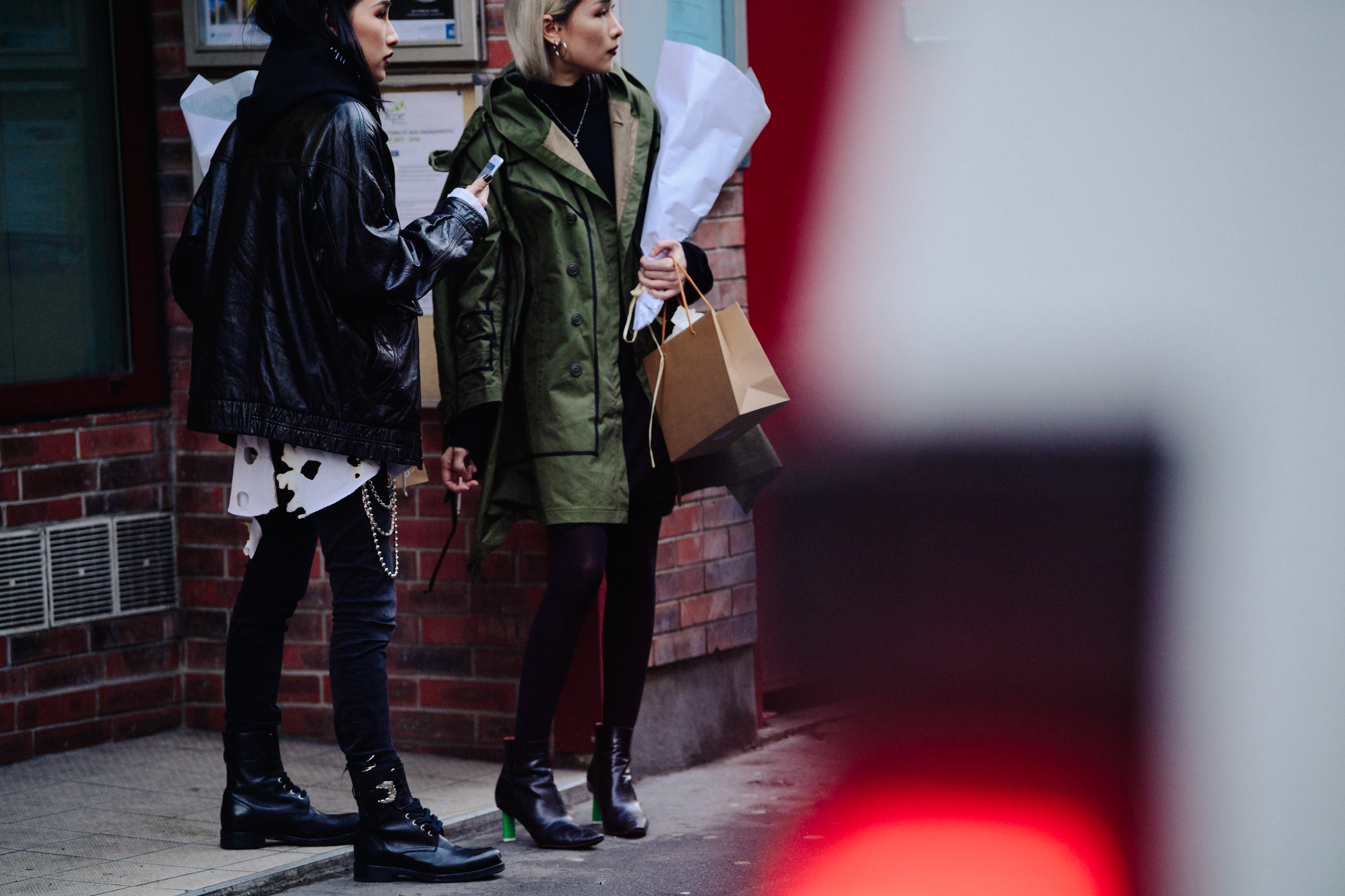 Two Asian women wearing dark outfits