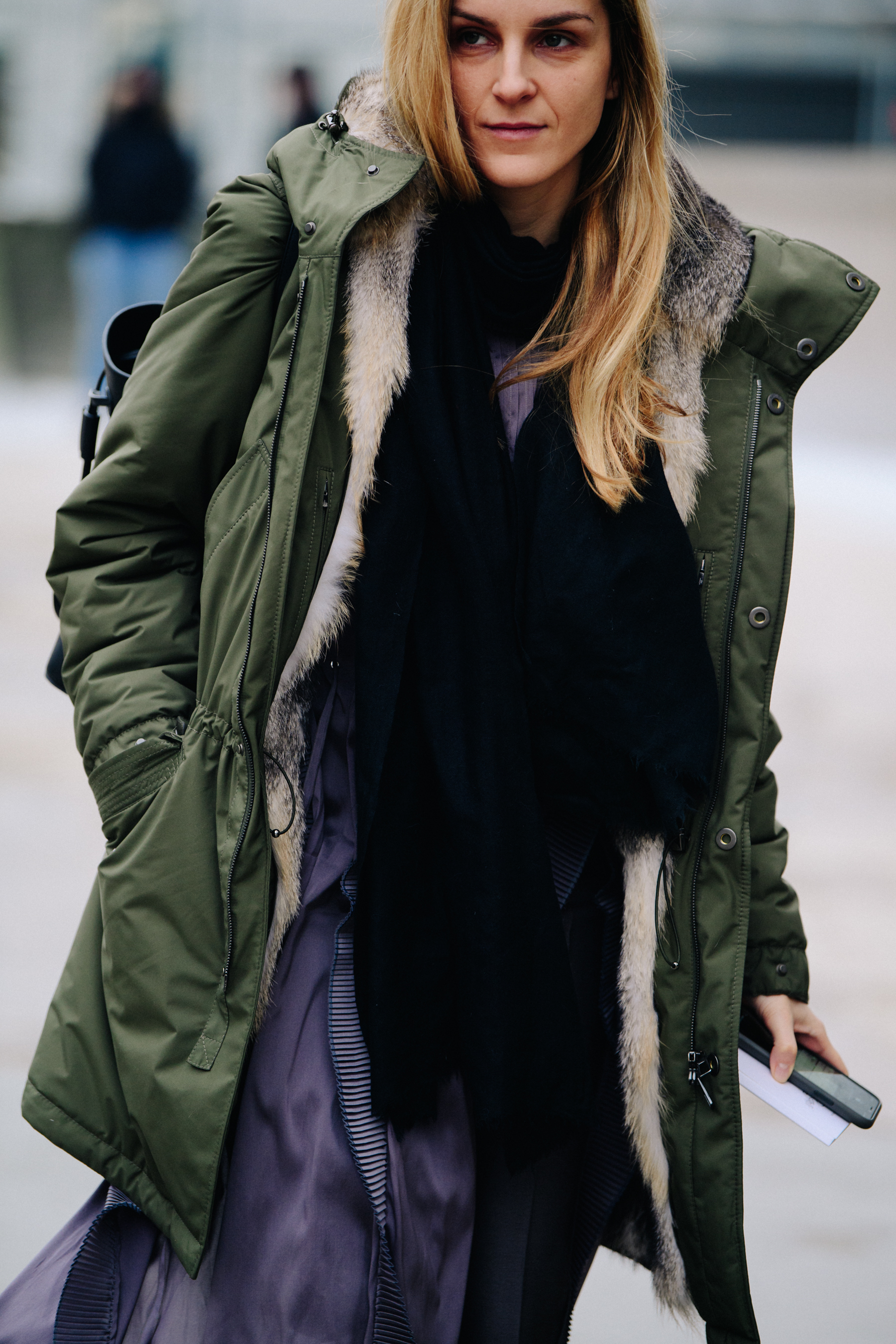 Woman wearing green and fur coat