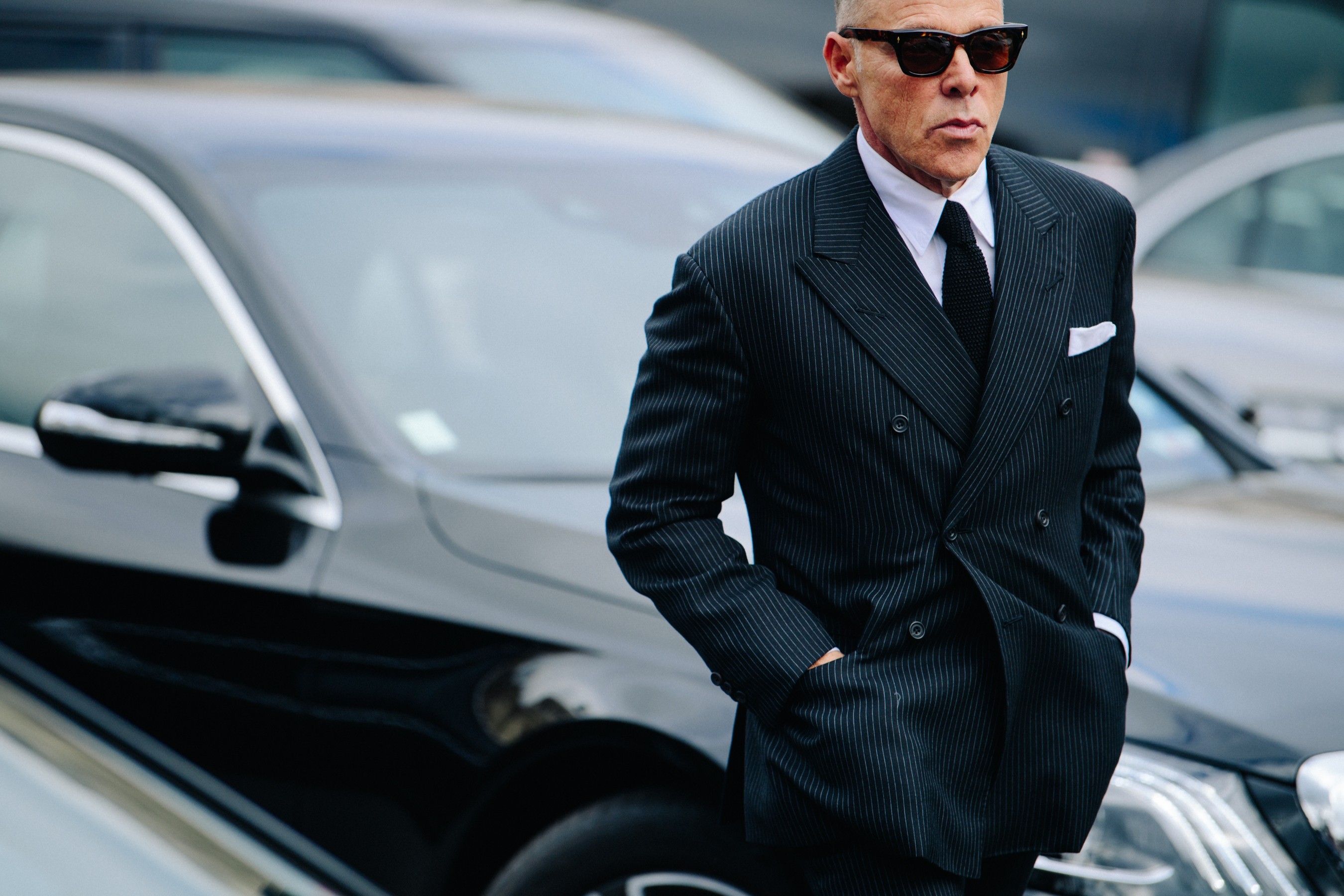 Man wearing black pinstripe jacket