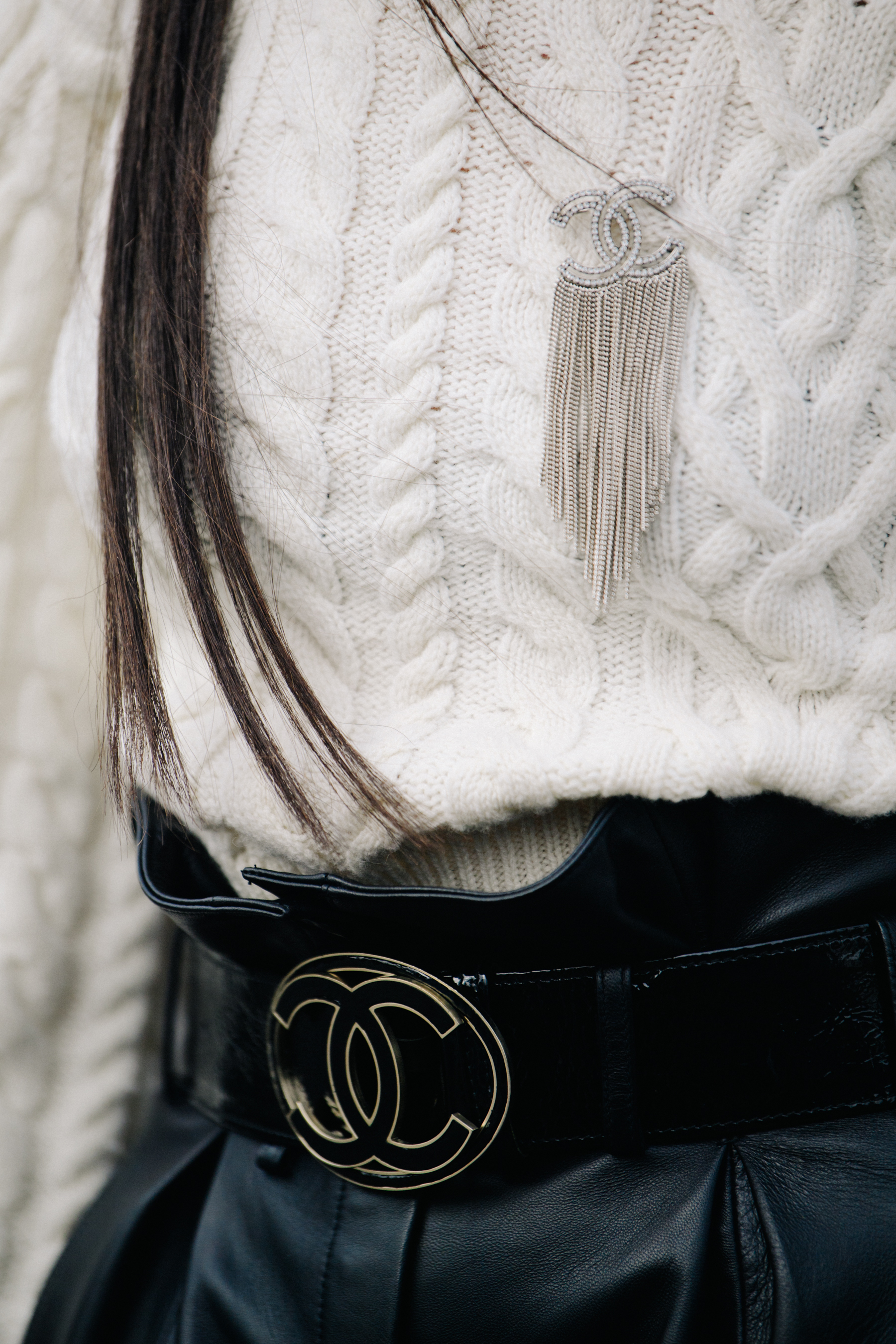 Woman wearing Chanel pin and belt
