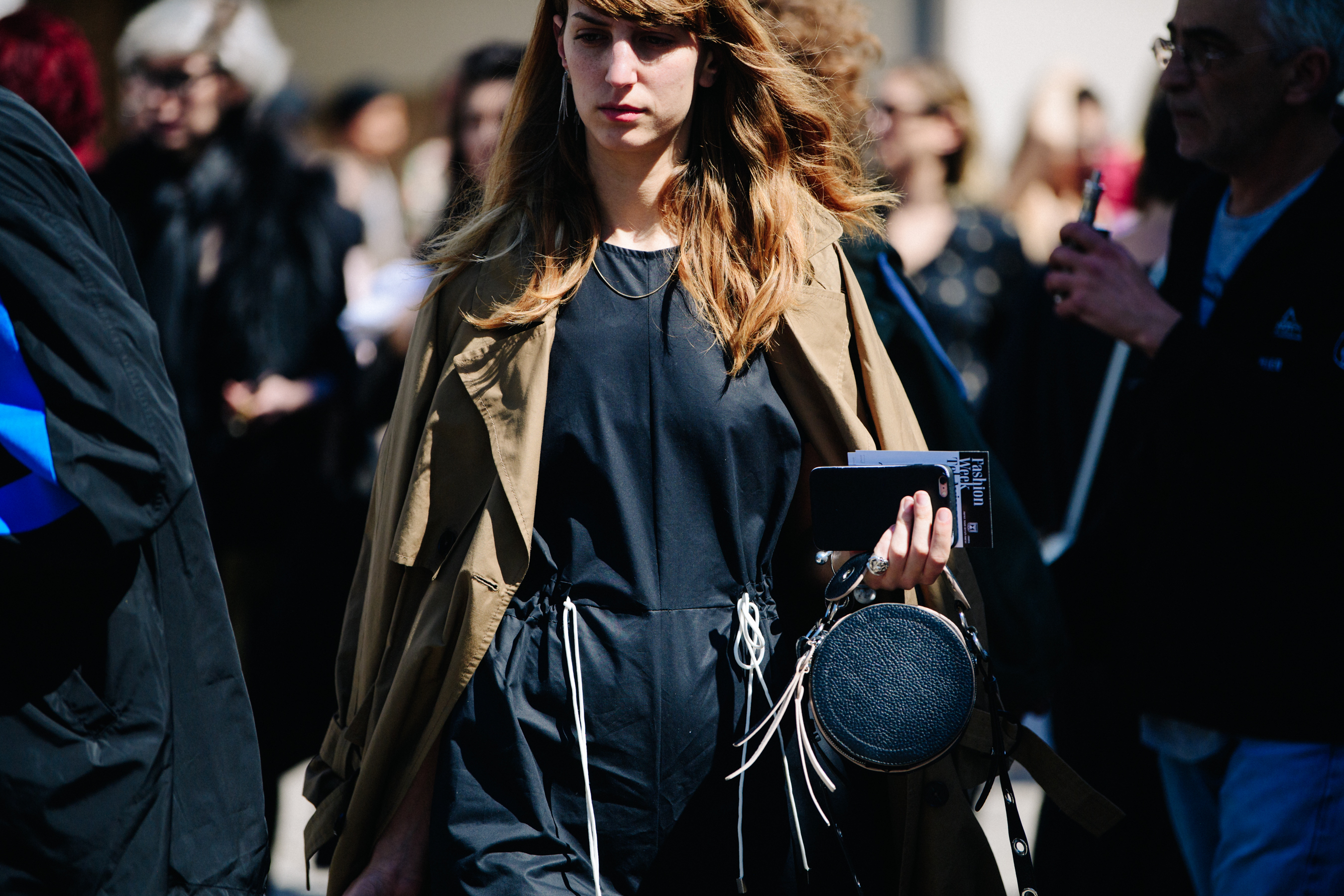 Woman wearing tan overcoat
