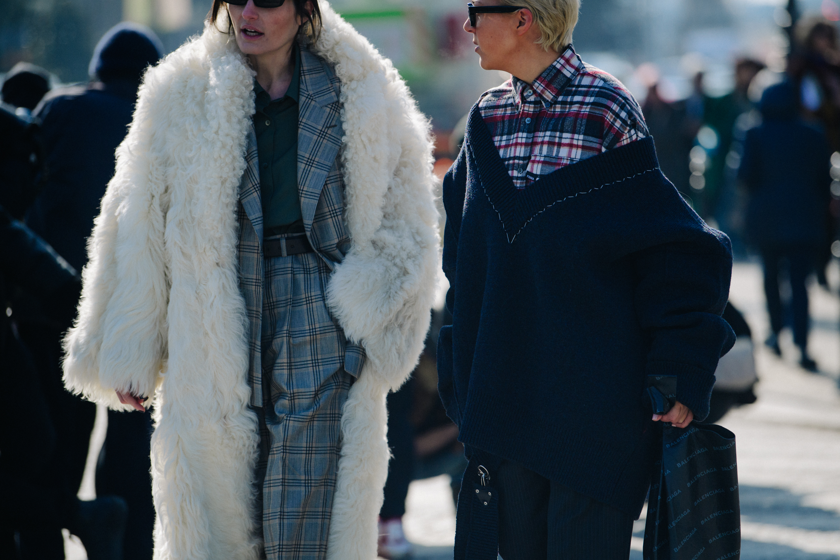 Two women wearing long winter outfits