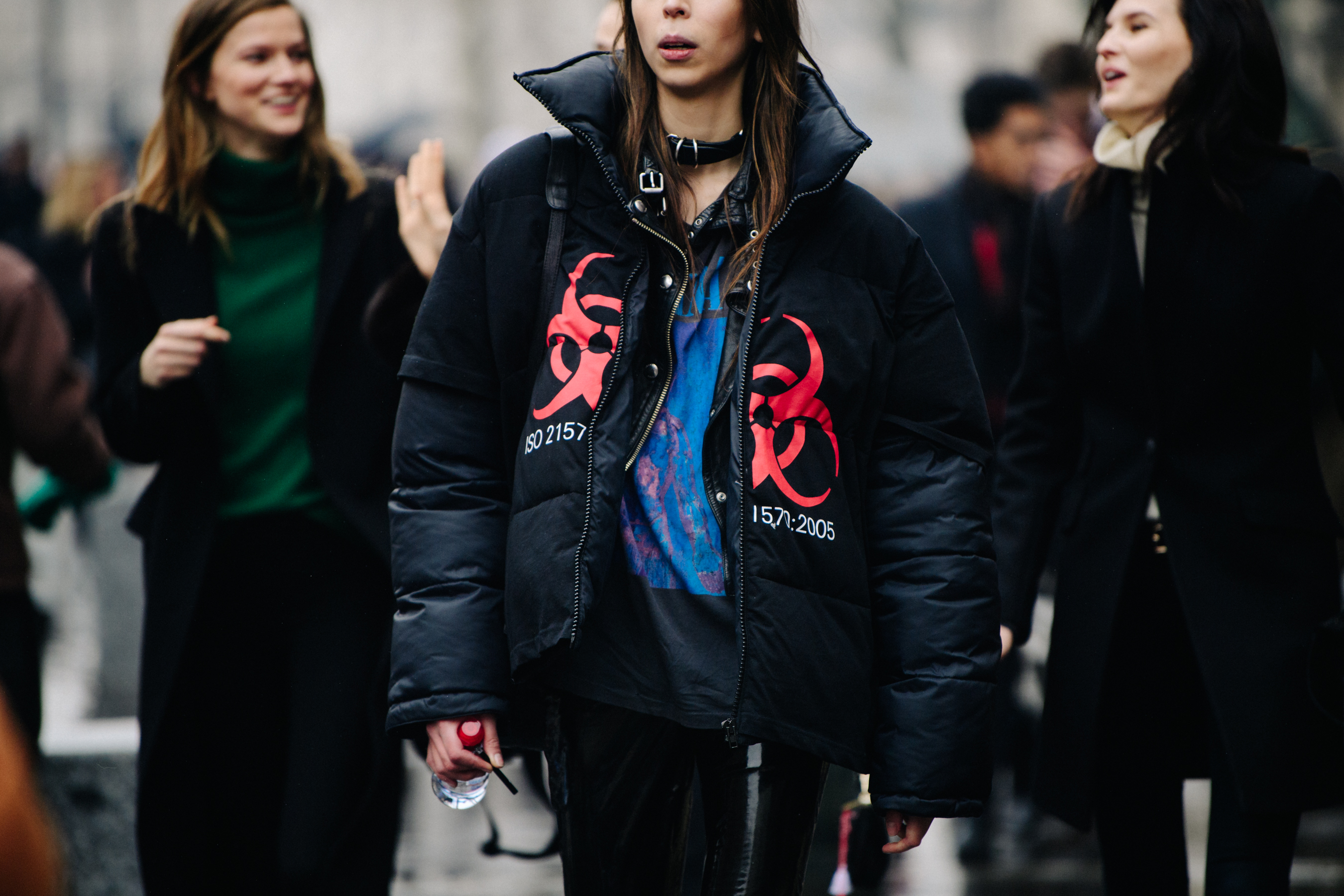 Model wearing black logo coat