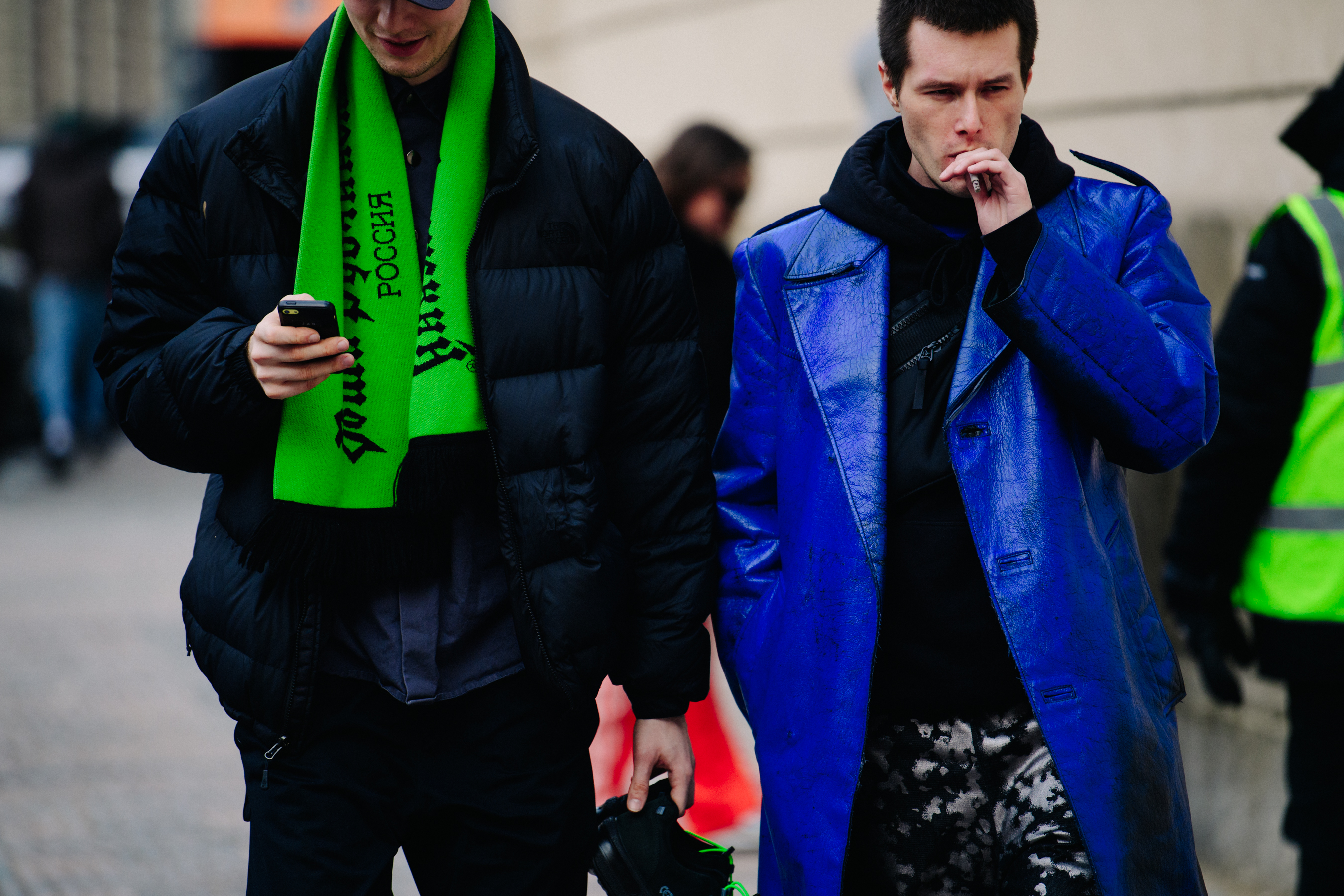 Two men wearing green and blue