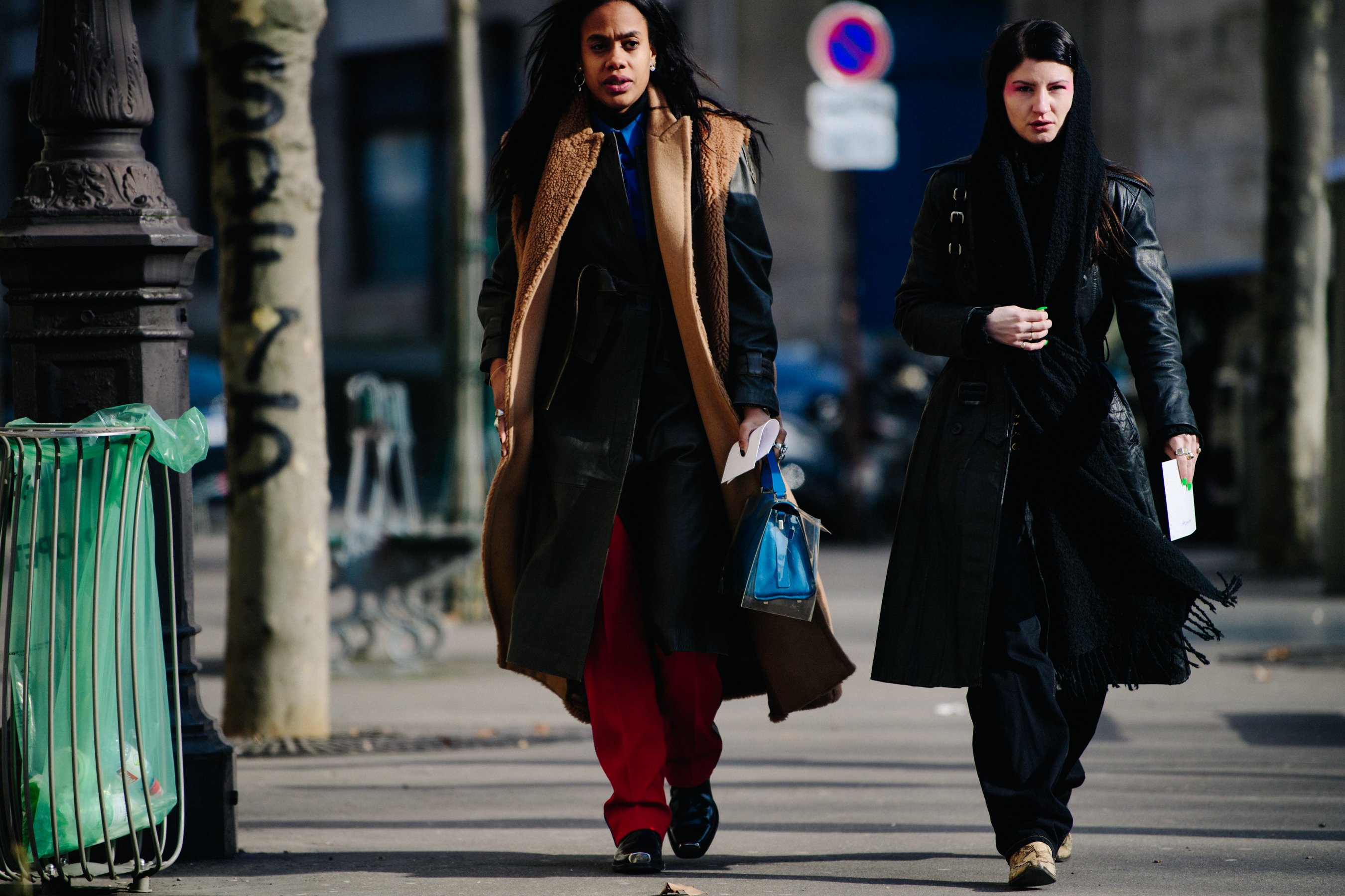 Two women wearing black coats
