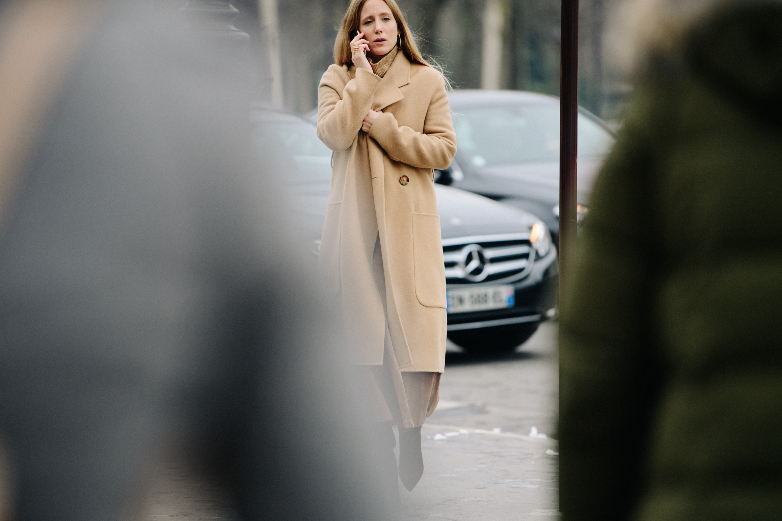 Woman wearing long tan coat
