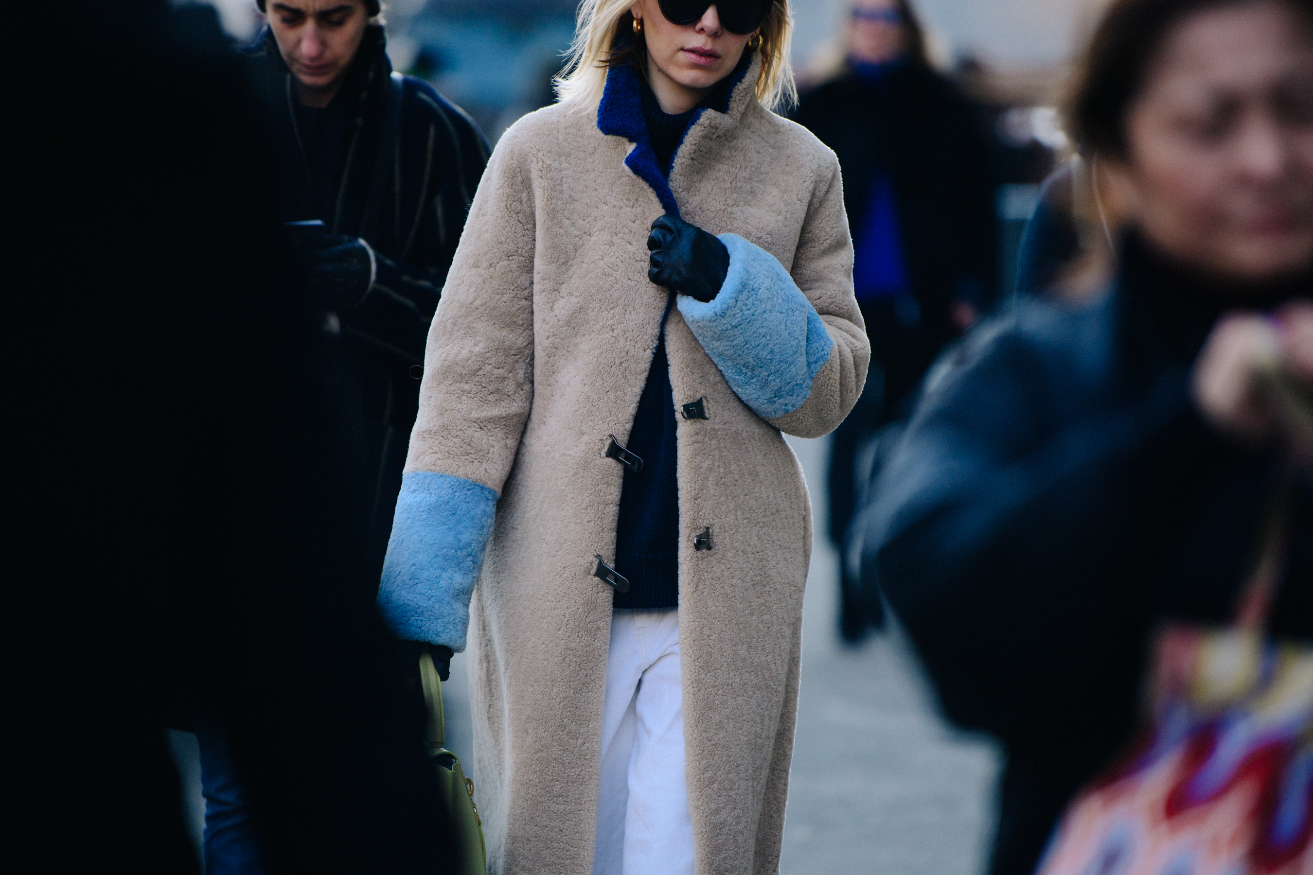 Woman wearing long shearling coat