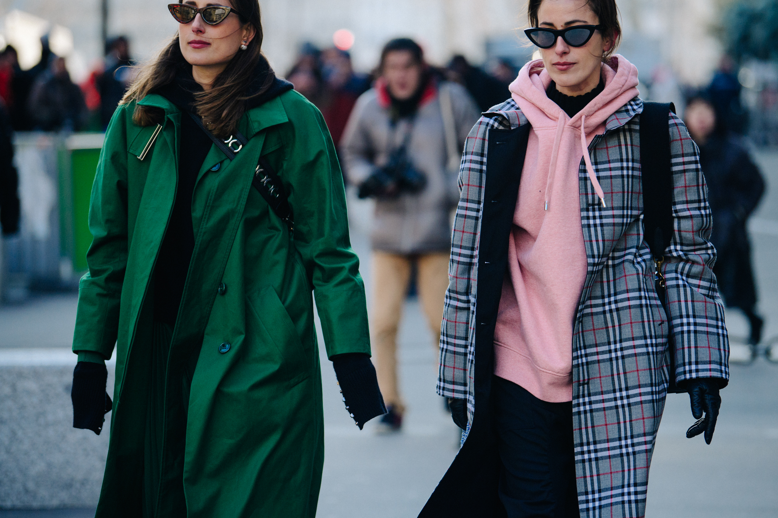 Two sisters wearing matching sunglasses