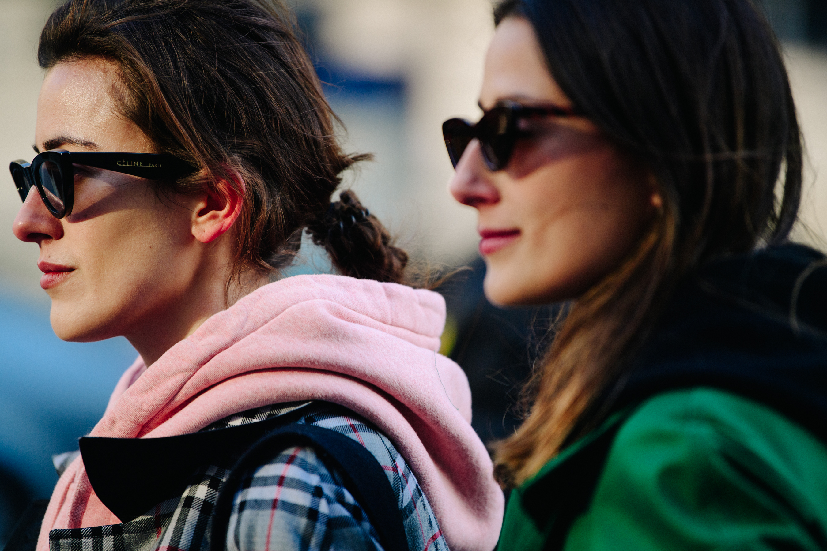 Two sisters wearing matching sunglasses
