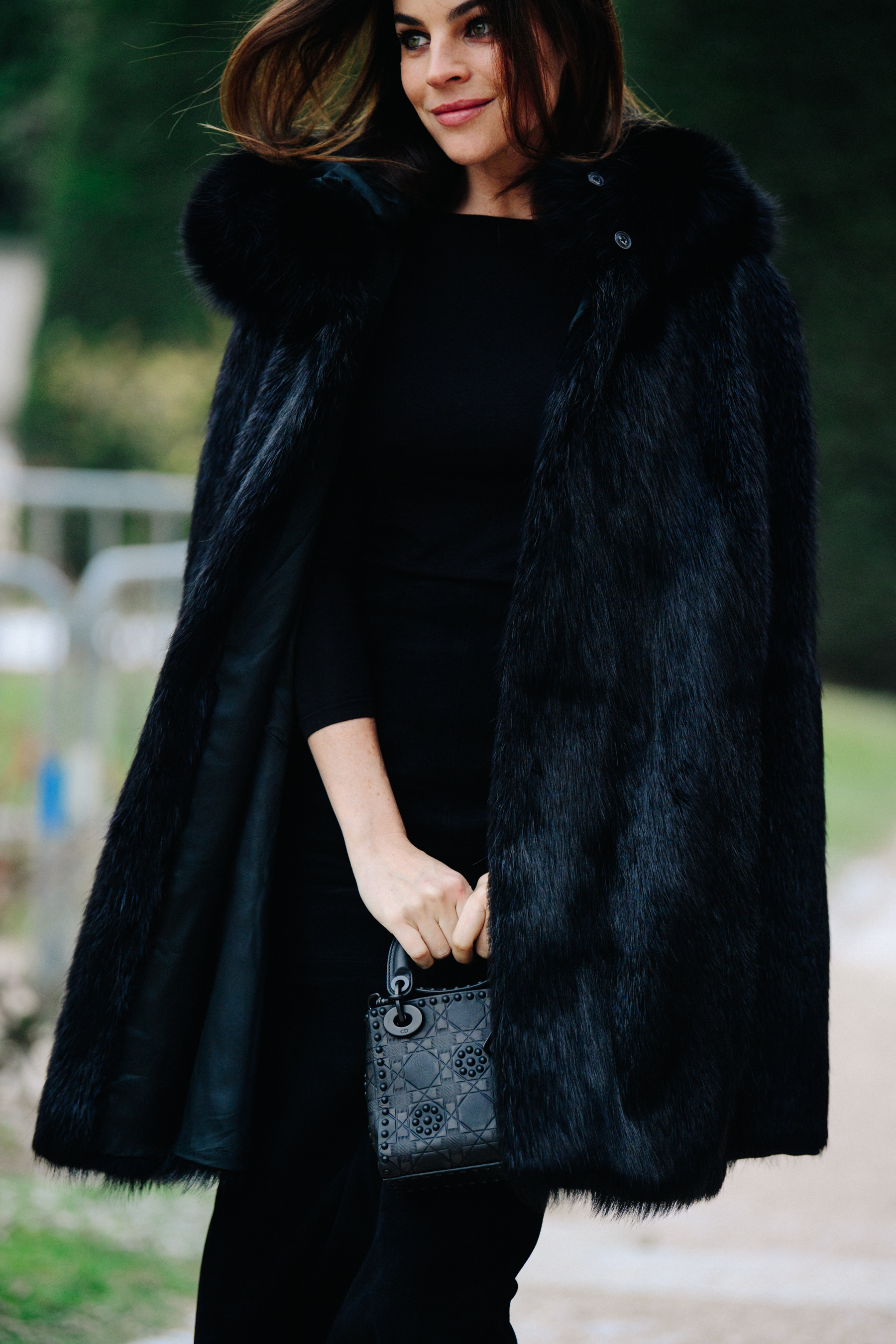 Woman wearing black fur coat