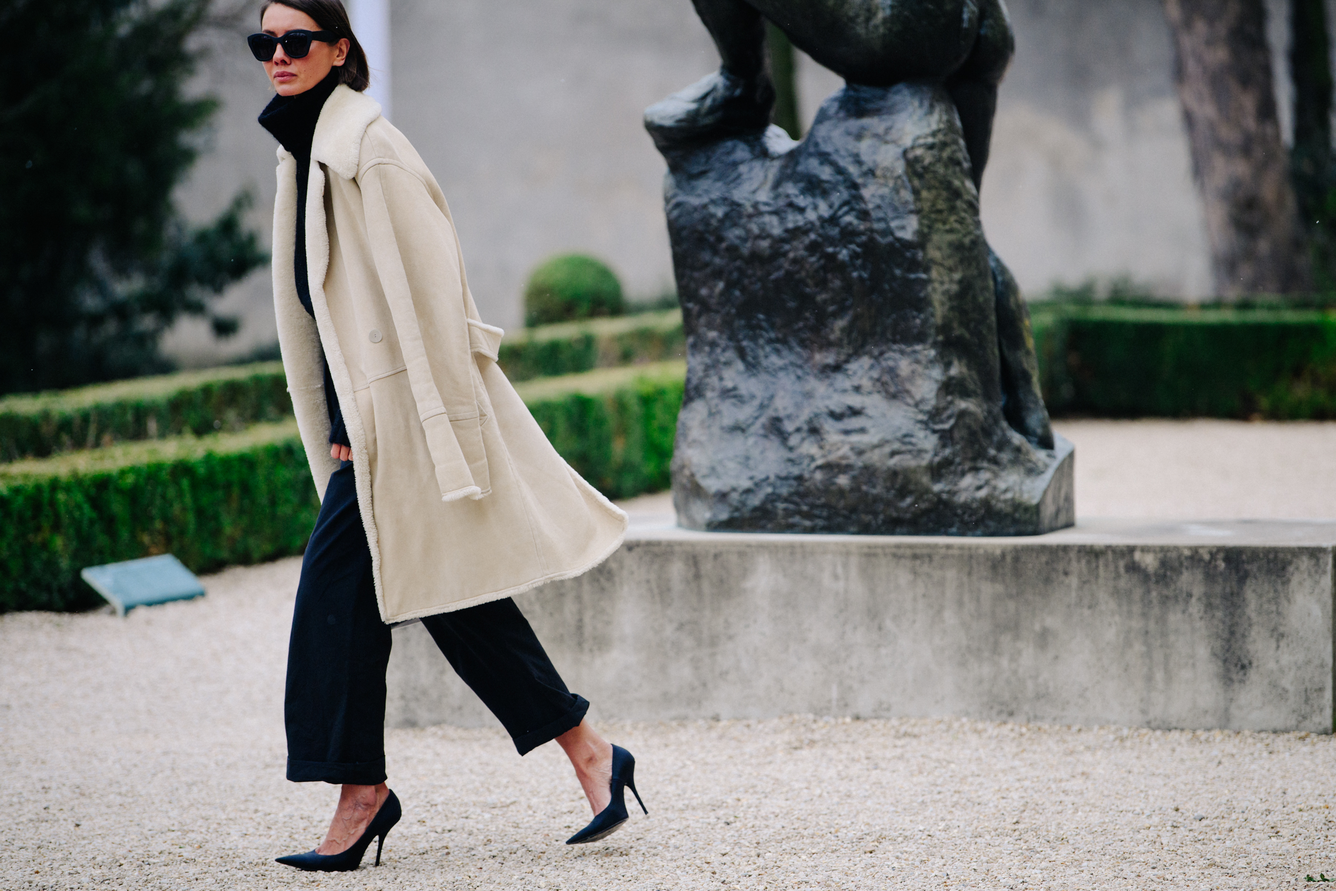 Woman wearing long shearling coat