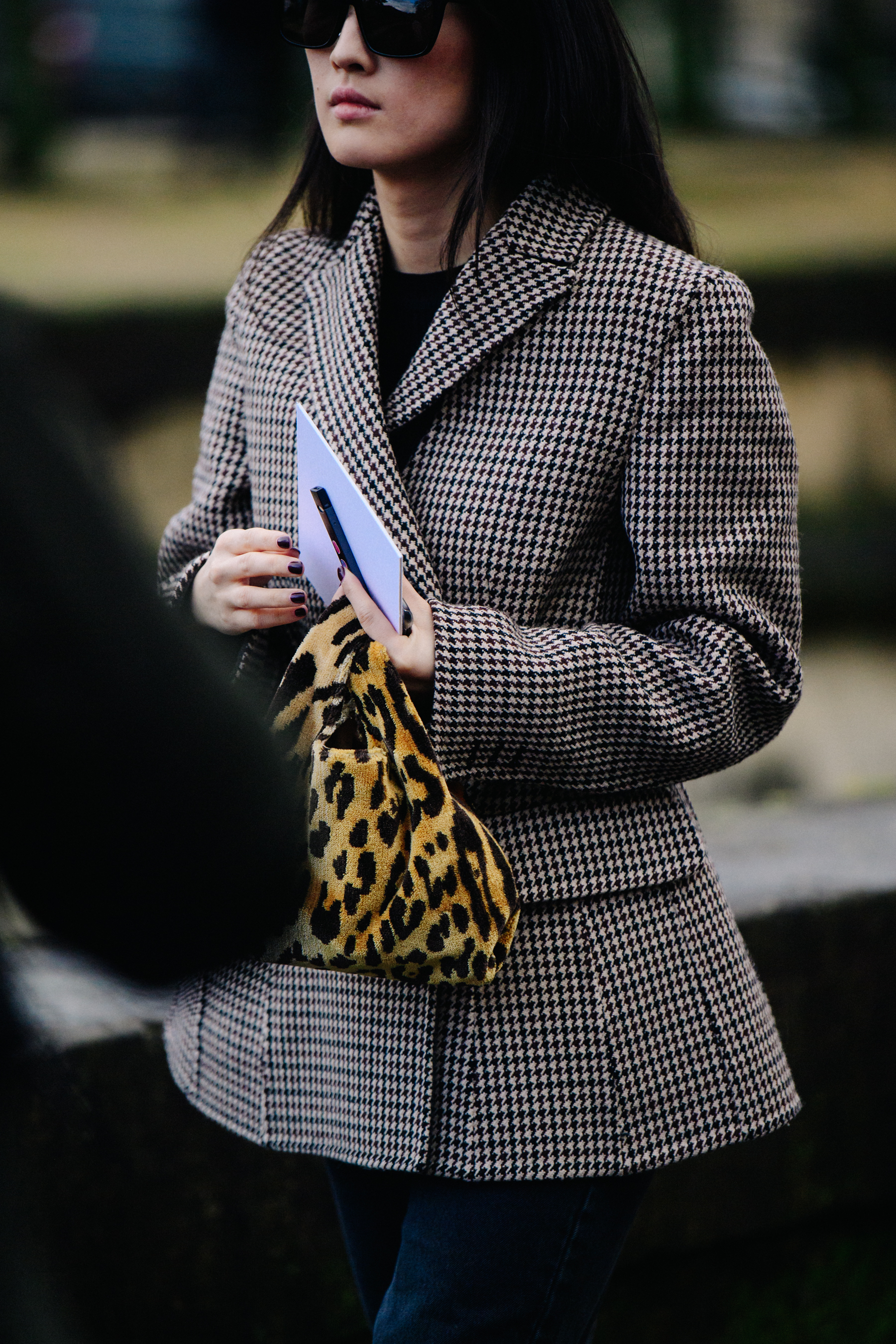 Asian woman wearing herringbone jacket
