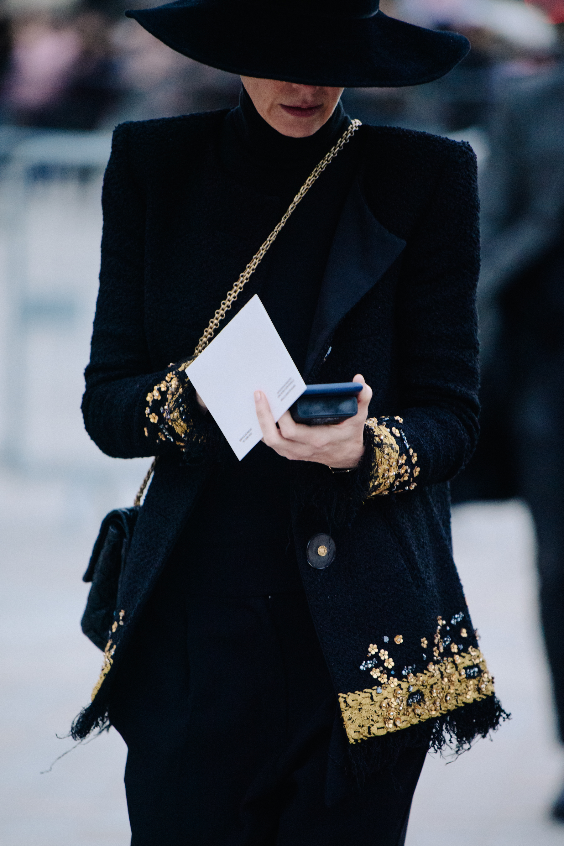 Woman wearing black and gold jacket