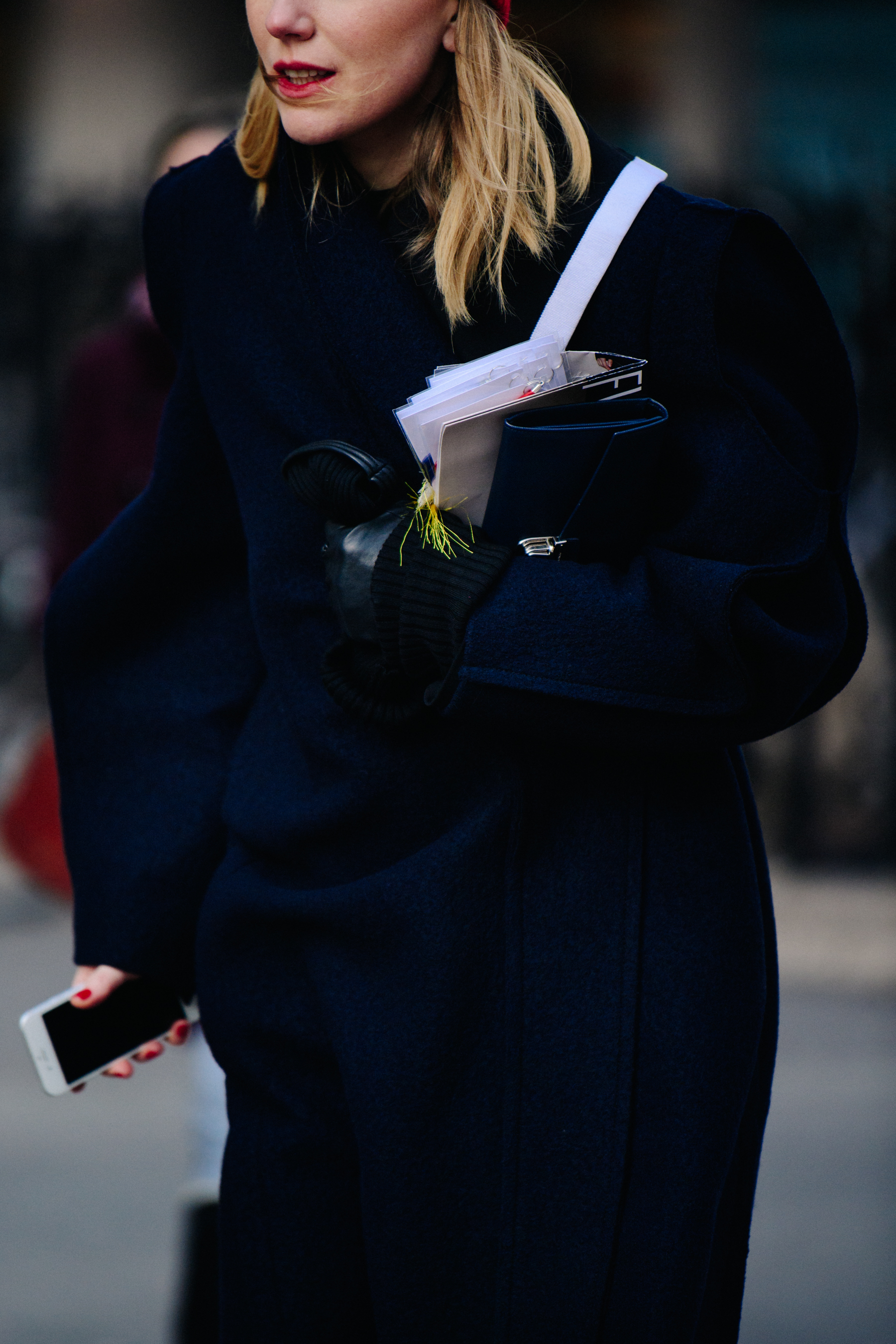 Woman wearing long navy coat
