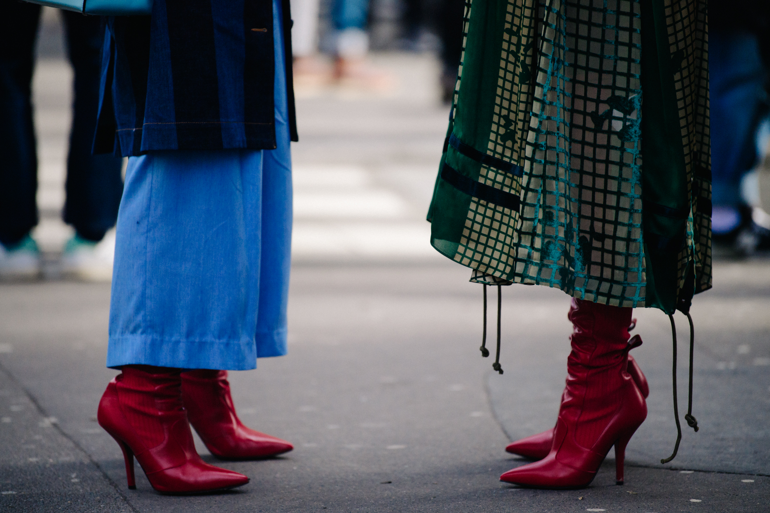 Two women wearing matching red heels
