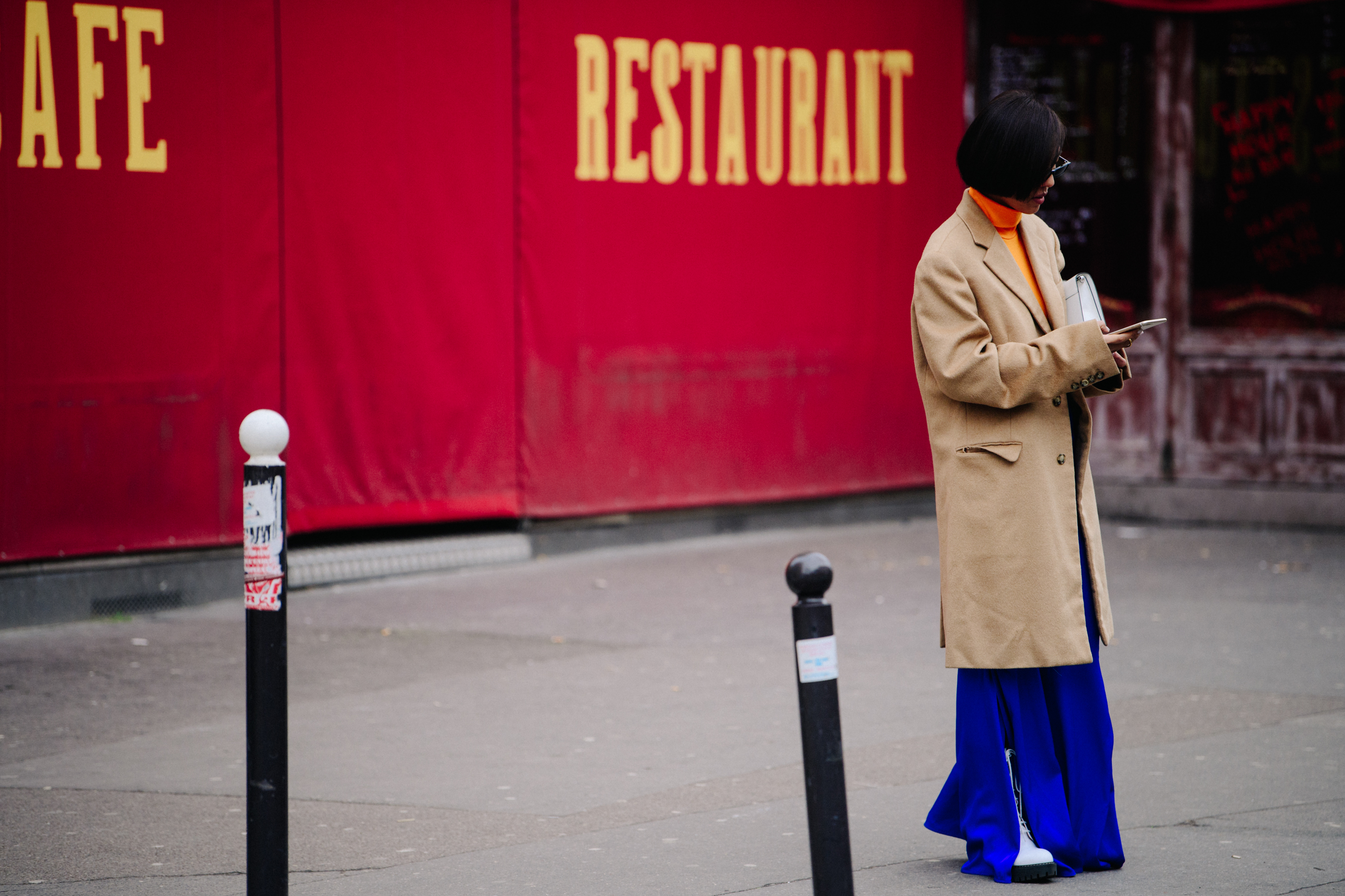 Asian woman wearing tan coat