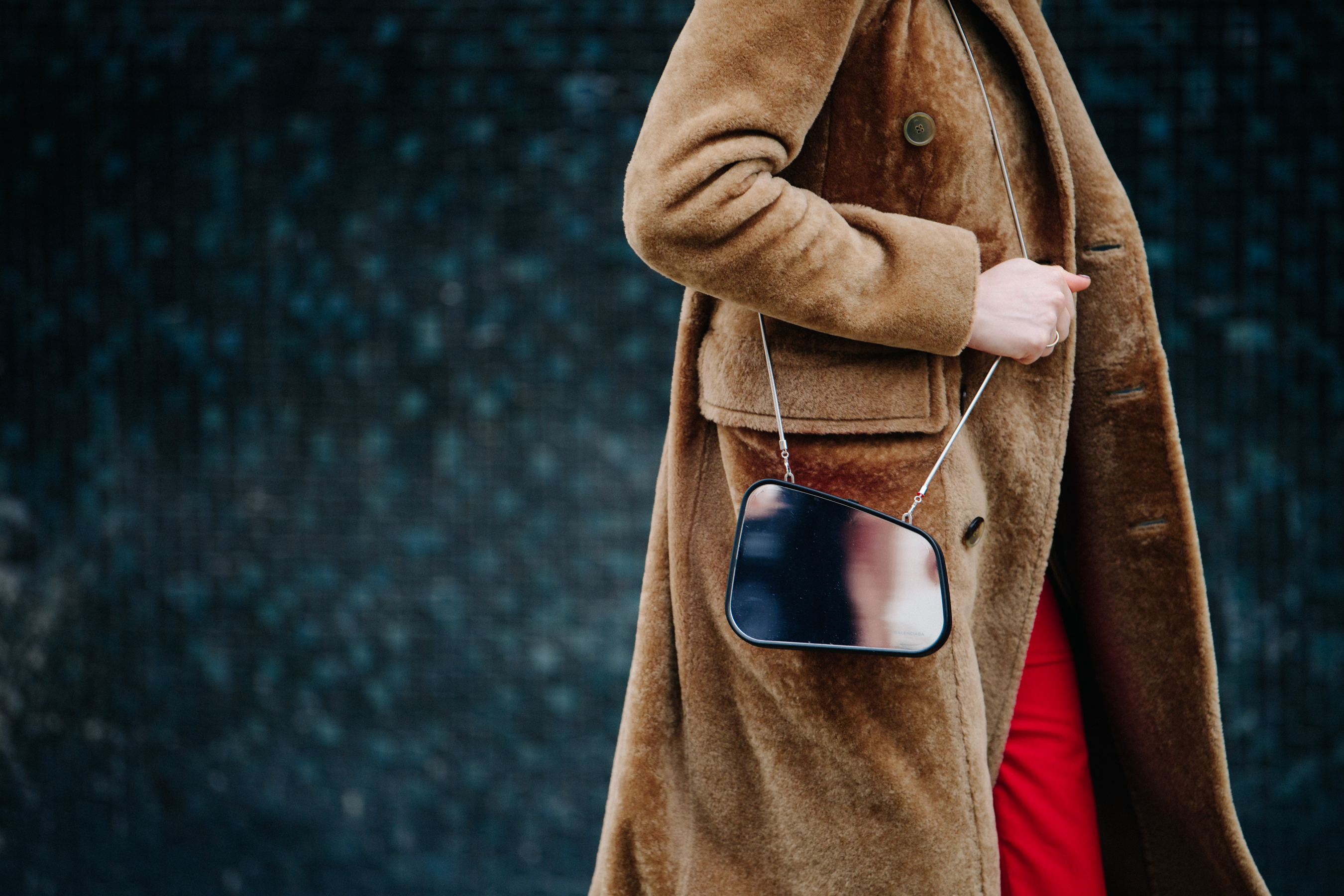 Woman carrying reflective mirror bag