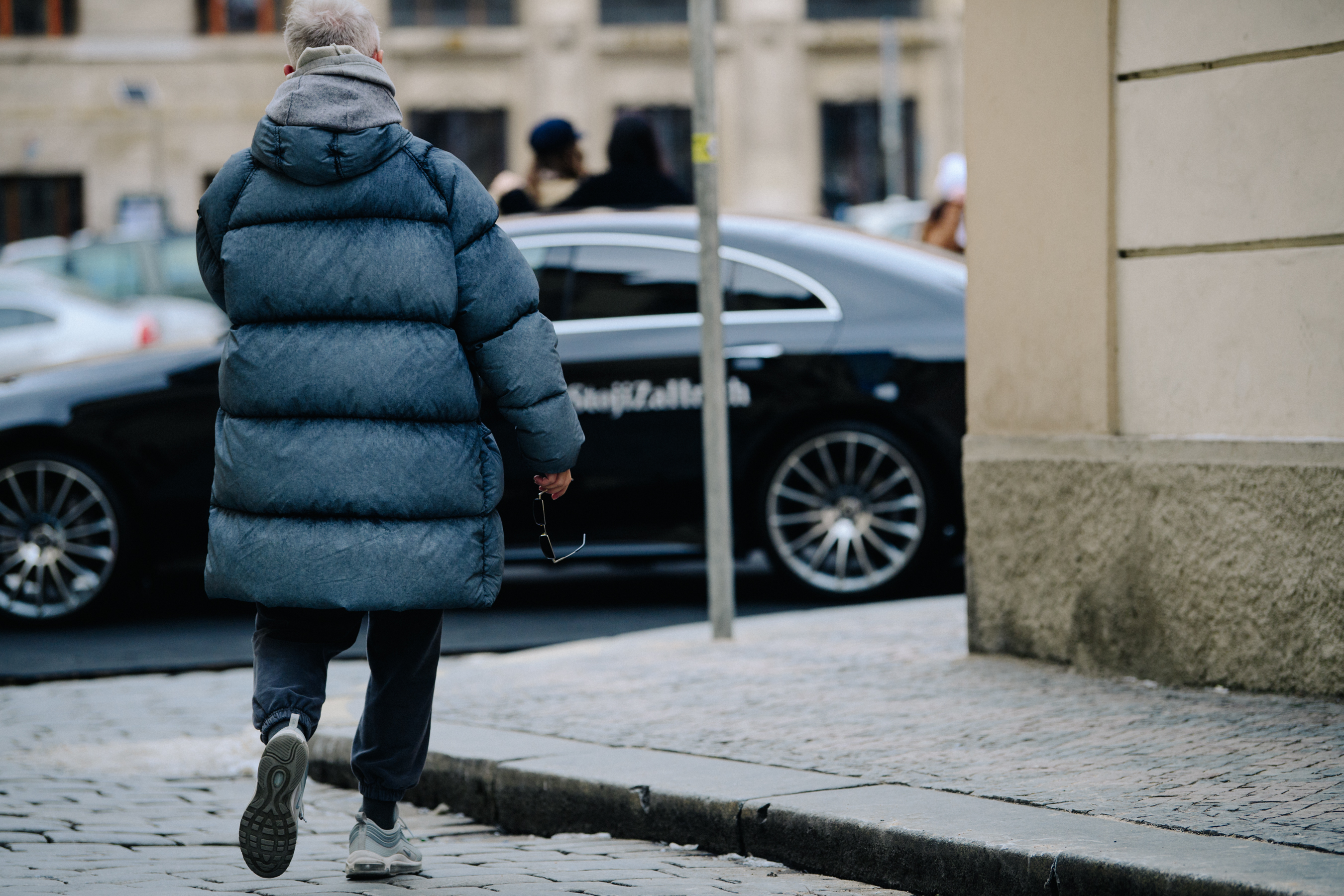 Man wearing grey puffer coat