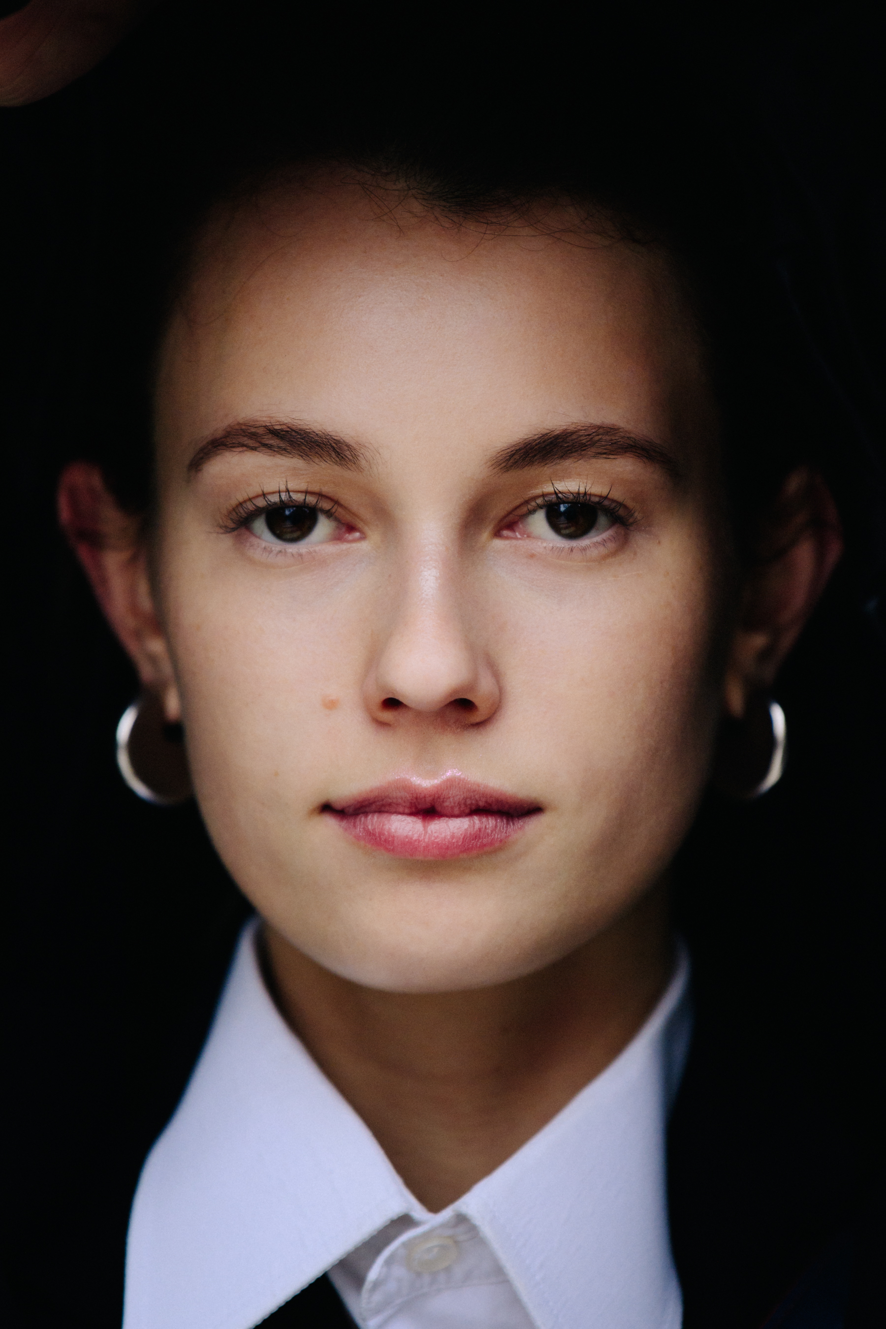 Portrait of model wearing silver earrings