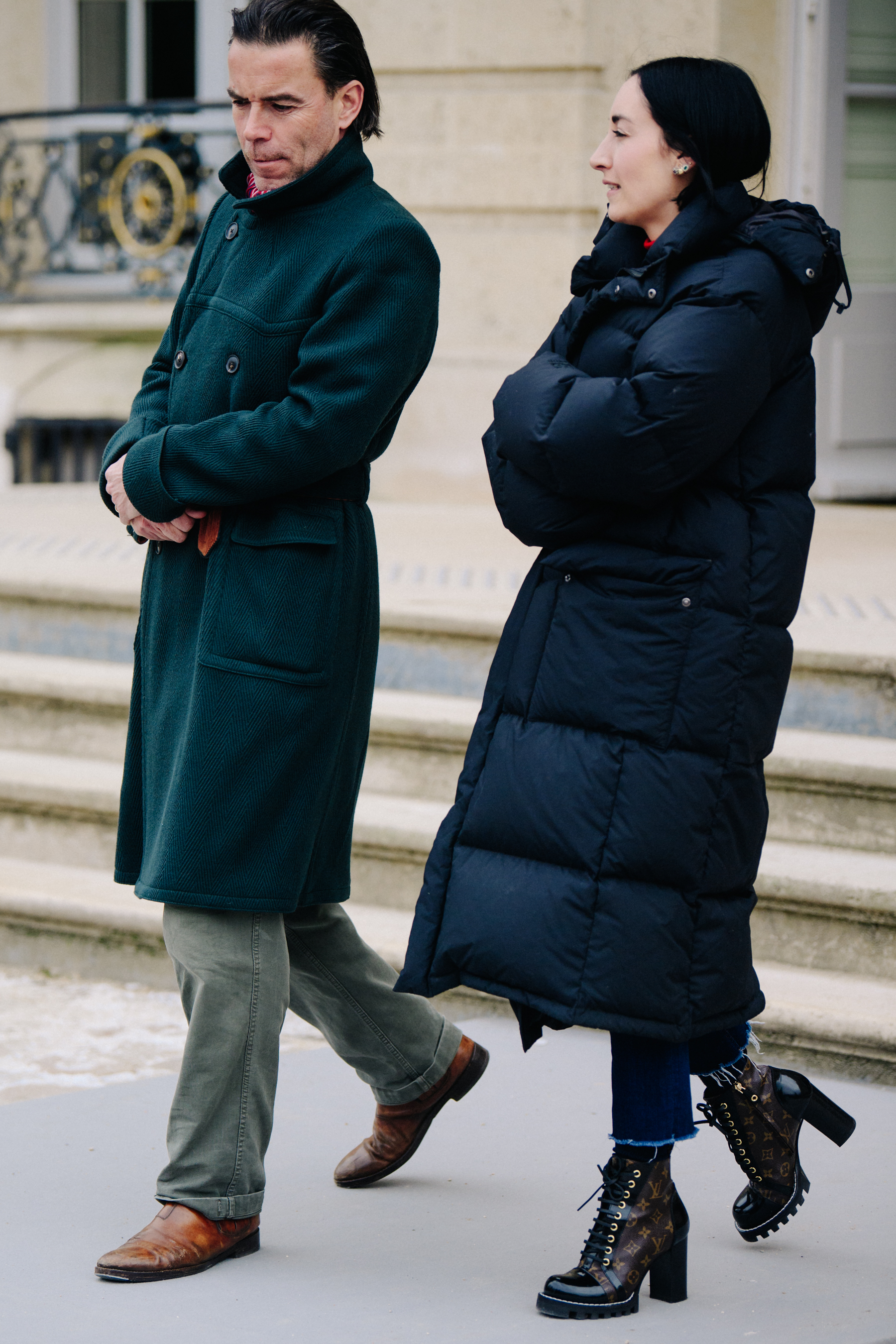 Two editors wearing long dark coats